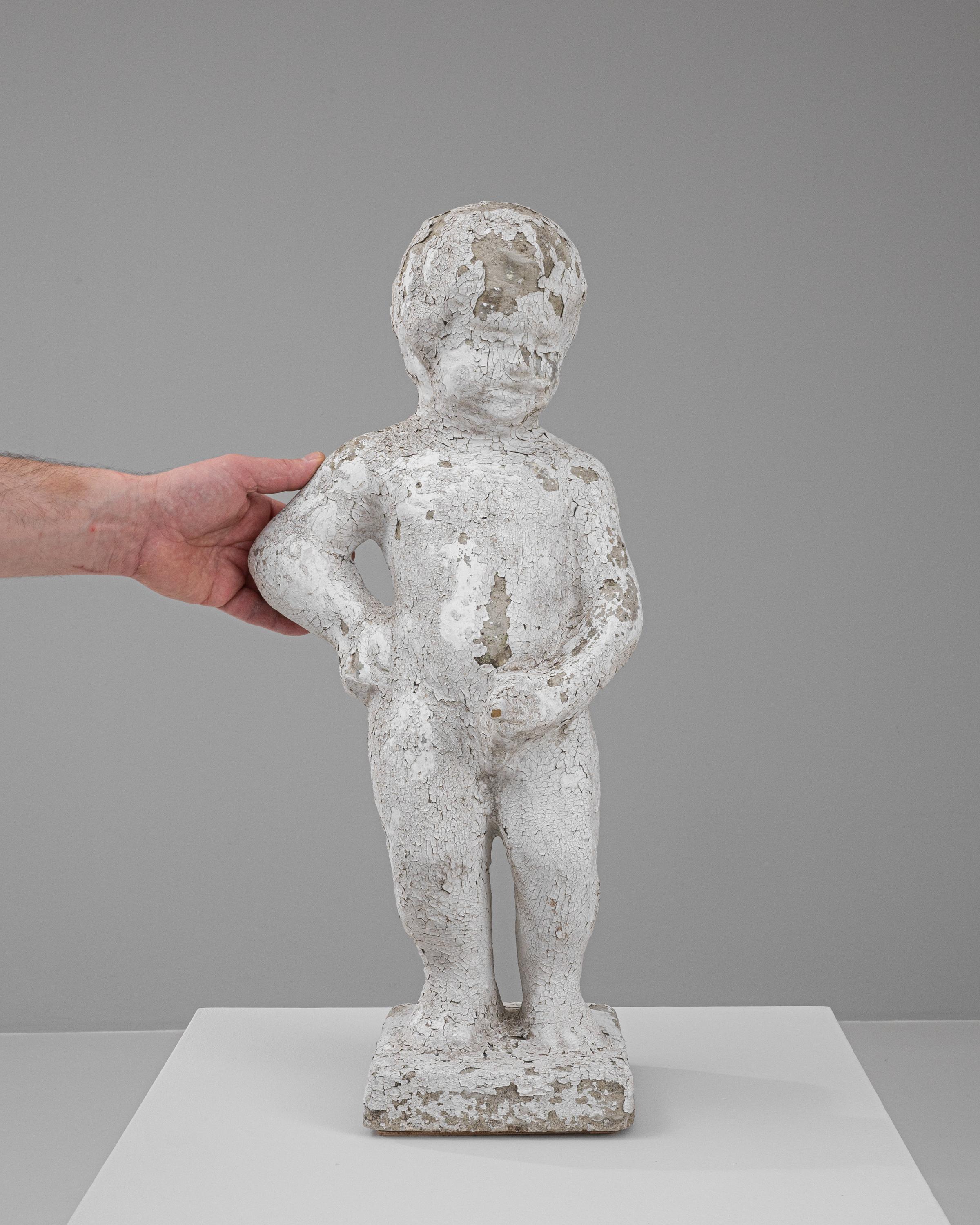Add a touch of eclectic charm to your collection with this 20th Century Belgian concrete sculpture. Exemplifying a rustic and weathered aesthetic, this statue portrays a child in a playful stance, giving it a timeless appeal that captivates and