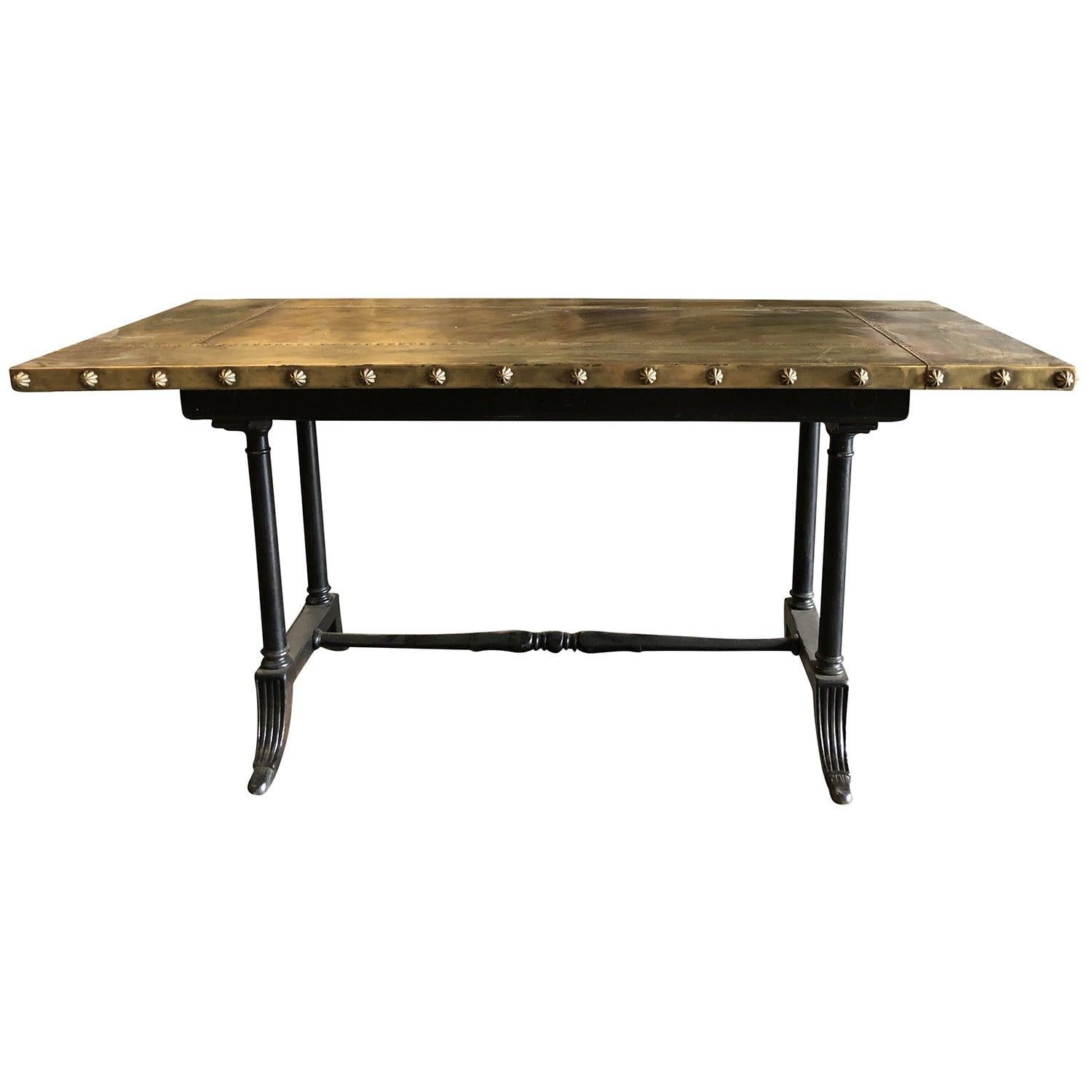 Early 20 century, a vintage Belgian Art Deco metal work table with hand crafted copper top and riveted border, in good condition. Aged patina, with a strong industrial aesthetic. The four legs uniquely shaped providing stability to the work surface.