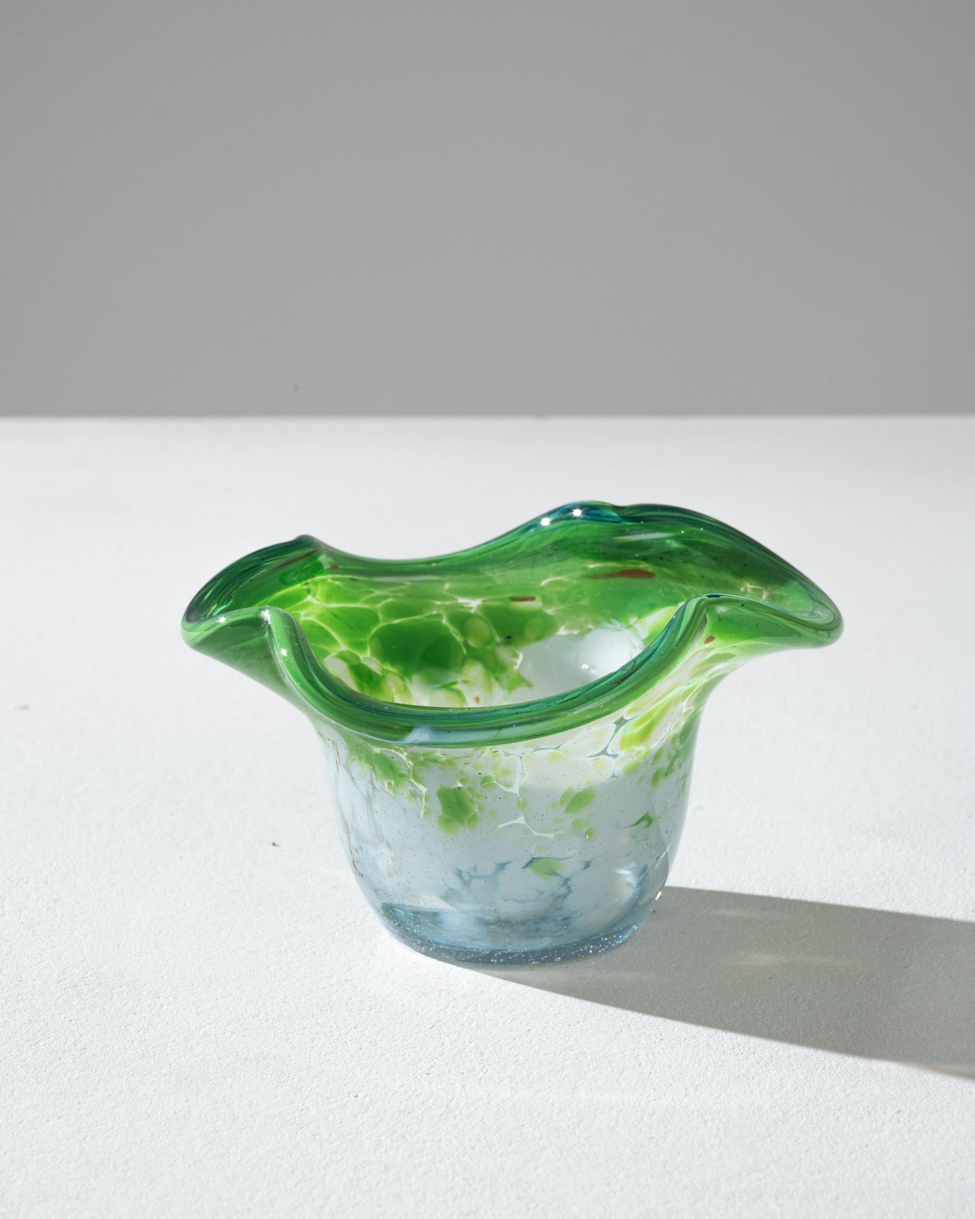 A charming piece of vintage glasswork, this small dish has an elegant, amphibious quality. Made in Belgium in the 20th century, the gentle asymmetric curves of the rounded form and the liquid pattern of swirling spots which decorate its surface
