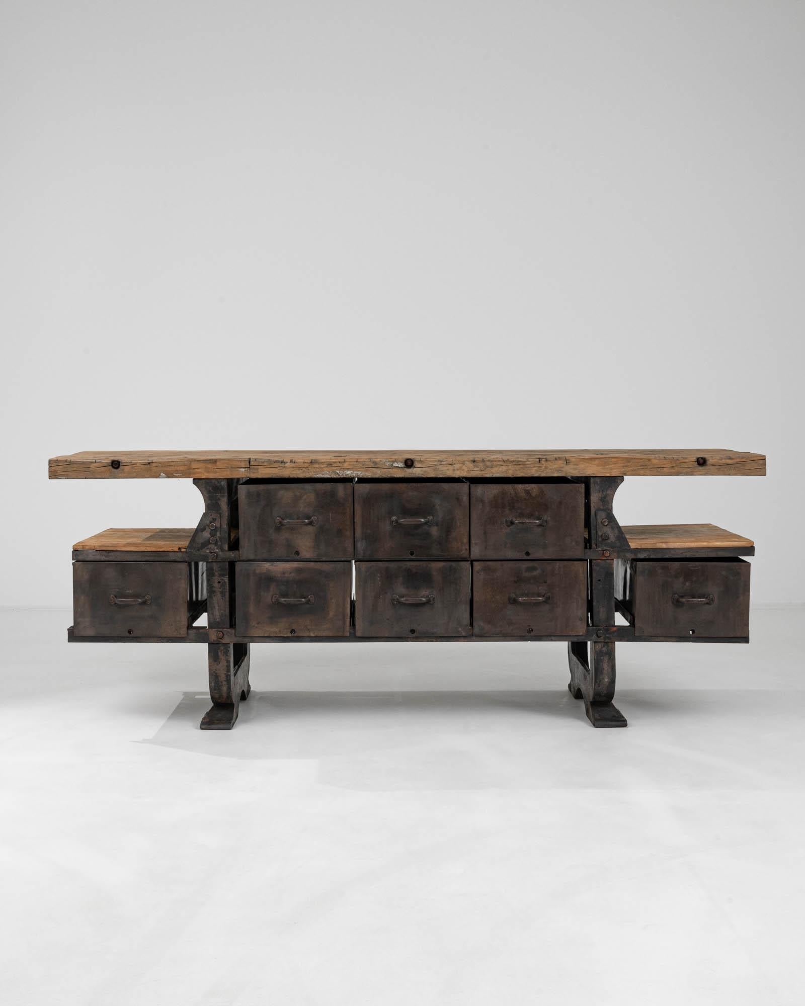 Introducing the 20th Century Belgian Industrial Table, a statement piece that blends rugged functionality with bold, architectural design. This substantial table features a robust wooden top that bears the rich patina of its industrial past,