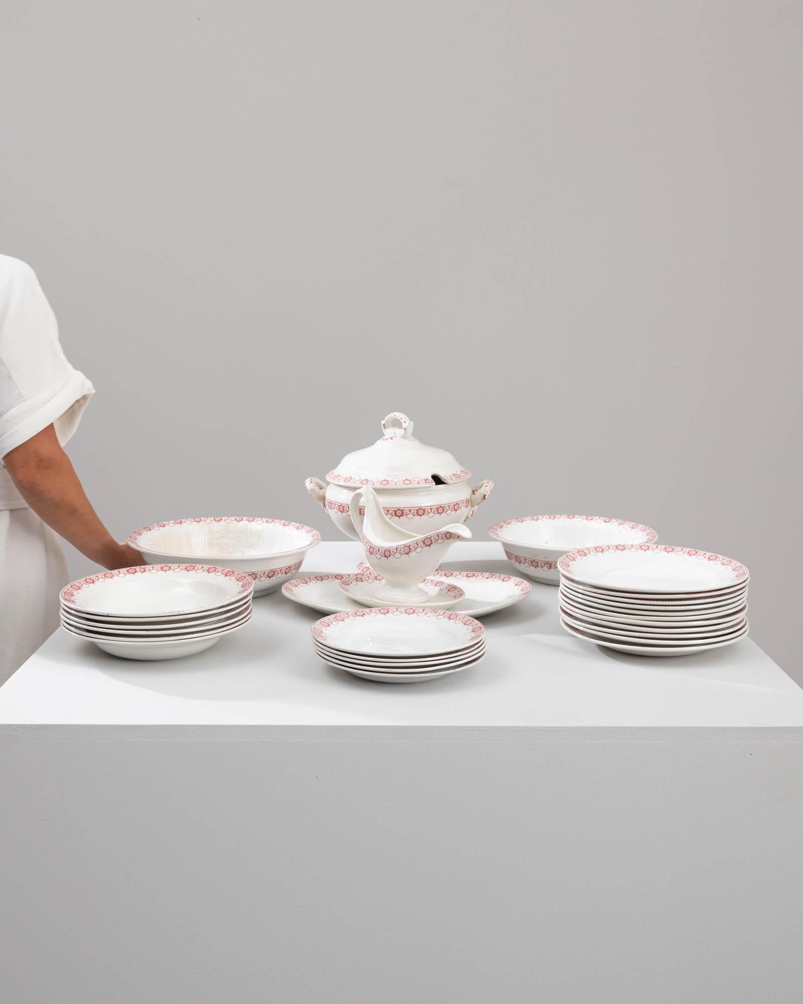 Rehaussez votre expérience culinaire avec cet exquis service de table en porcelaine belge du 20e siècle, composé d'un ensemble complet de 26 pièces magnifiquement travaillées. Chaque article est orné d'un délicat motif floral rouge qui ajoute une