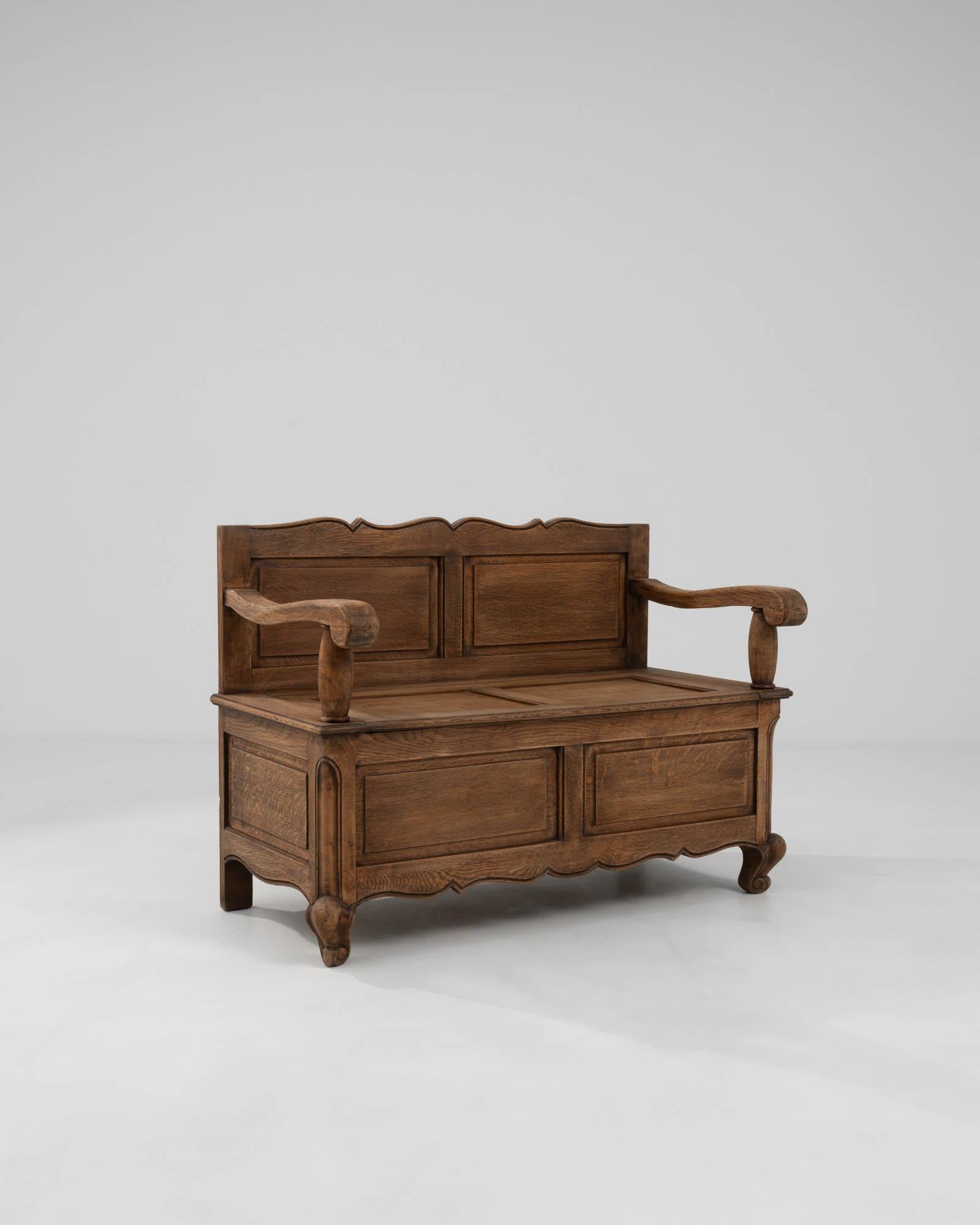 This 20th Century Belgian Wooden Bench captures the essence of rustic charm and old-world craftsmanship. Its robust silhouette is characterized by a solid wood construction that promises durability and a timeless appeal. The bench showcases a