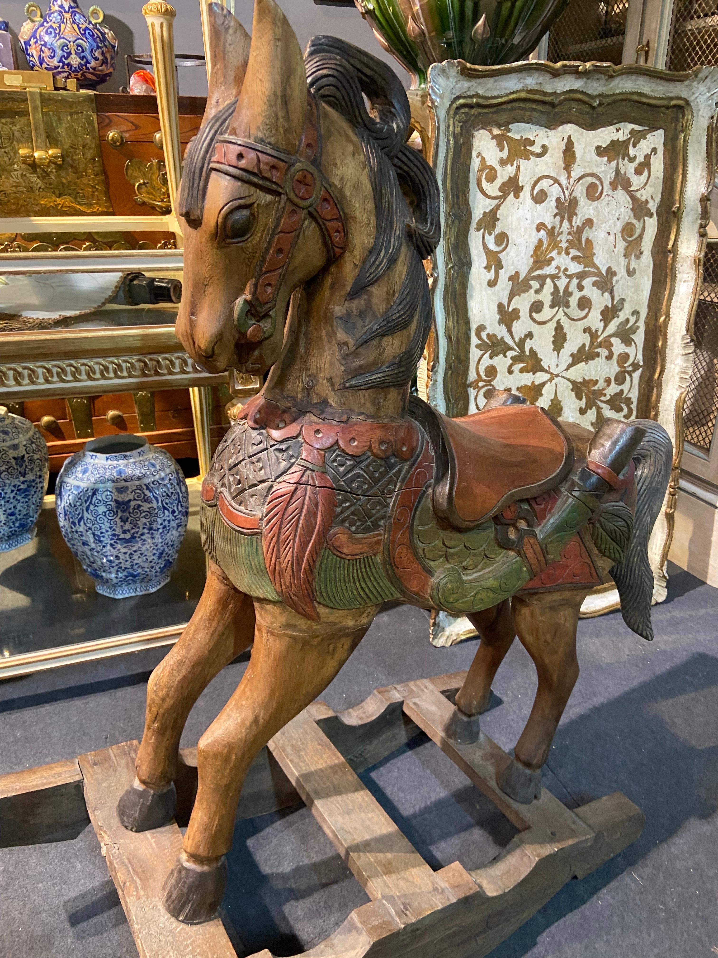 Charming wooden rocking horse beautifully painted in nice colours in very good condition. There are few cracks but they do not affect the stability of the piece. 
Belgium, circa 1920.