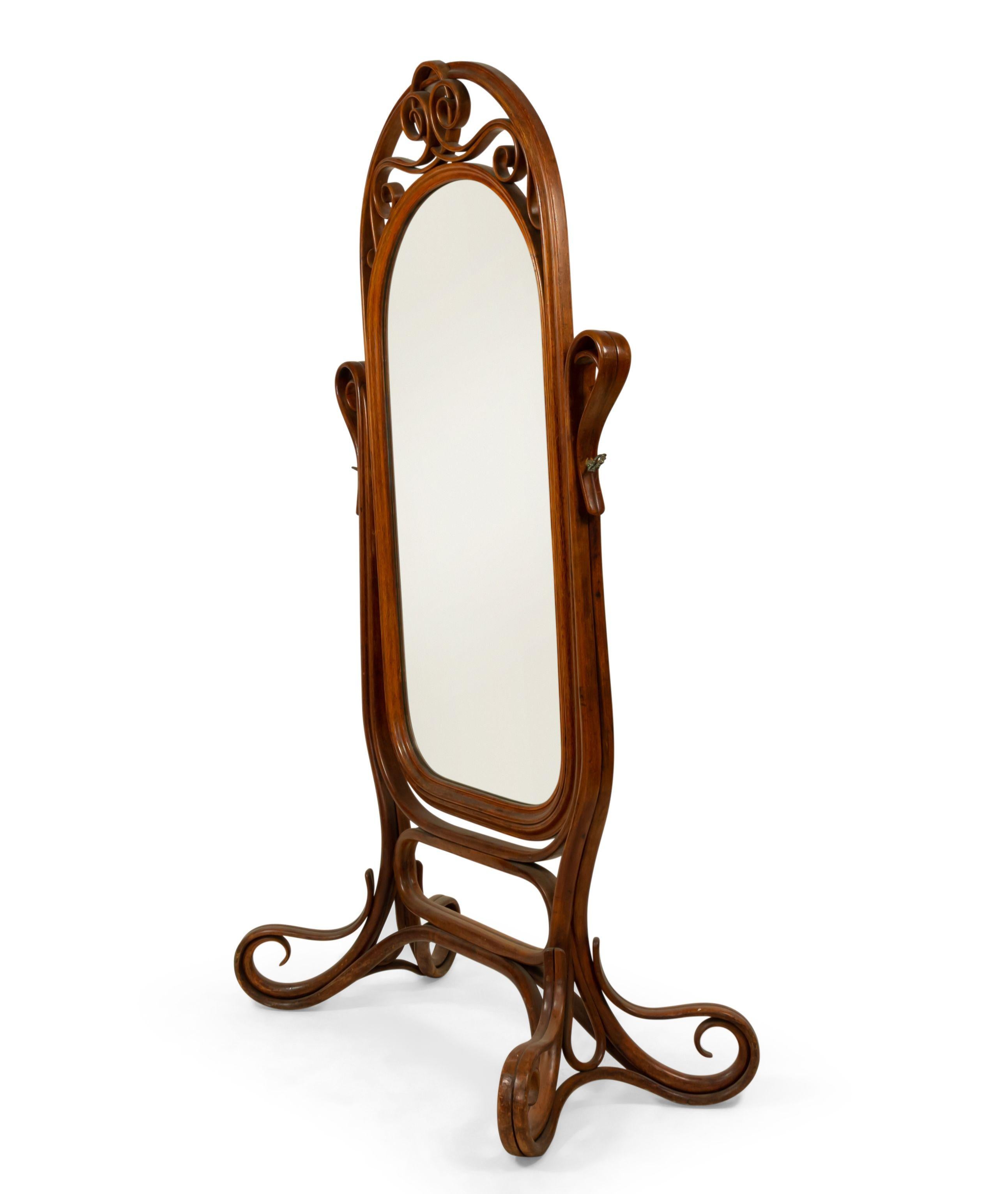 Bentwood (19th/20th Century) oak cheval mirror with ornate screw supports. (manner of Michael Thonet).
 