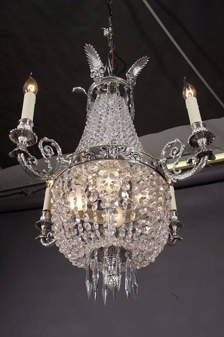 Basket chandelier in Biedermeier style.
Finely engraved, silver gilded brass. Hangings from finely ground crystal.

(F-Ra-30).