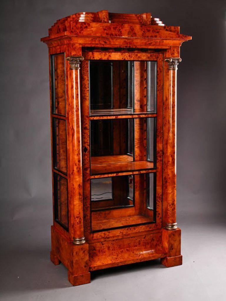 Bird’s eye maple root veneer on solid pinewood, one-drawered curving border-case on plinth-feet. Architecturally bowed front flanked with full columns from solid Beech. Carved and hand-painted capitals and bases. On three sides.

(O-Sam-35).
  