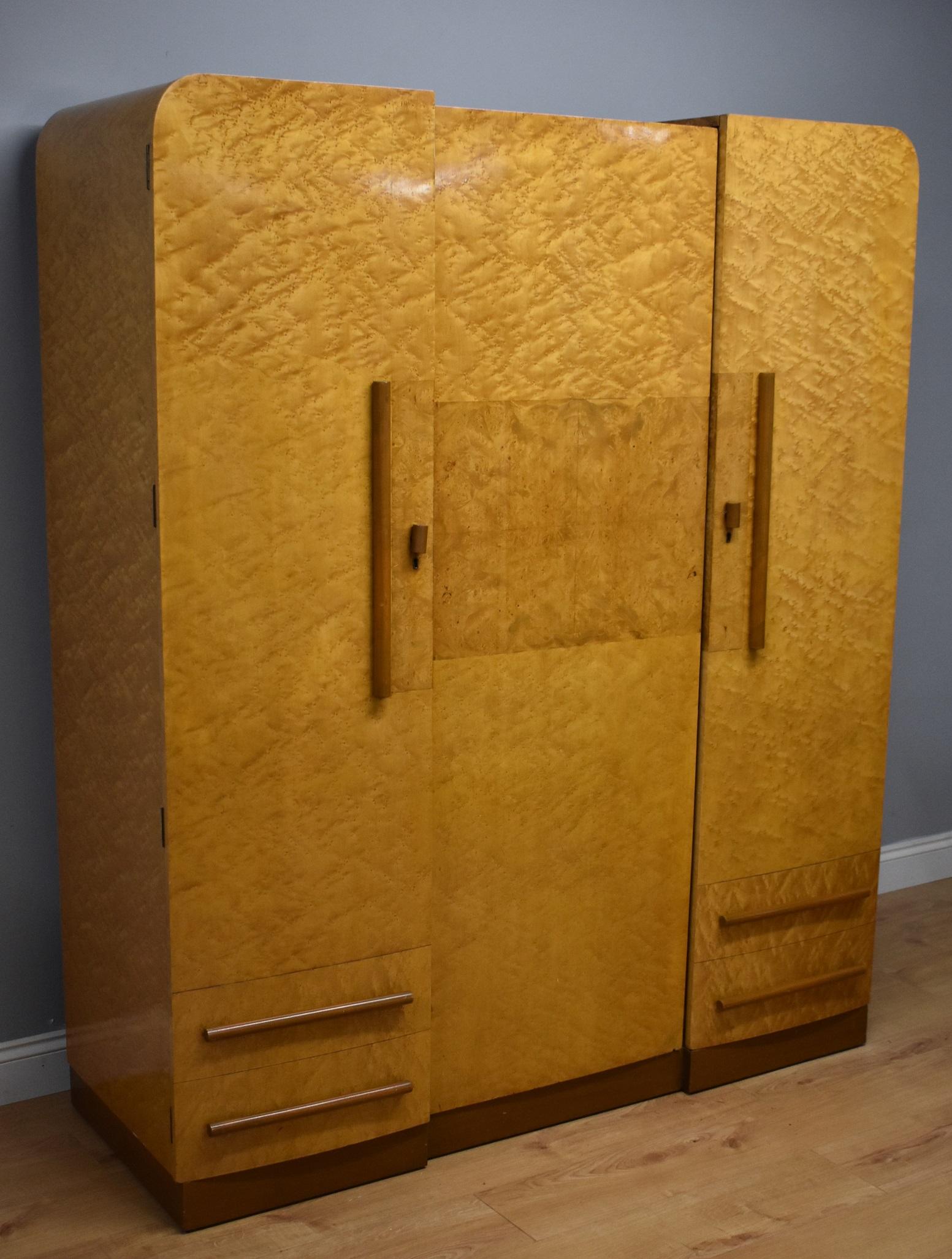 For sale is a good quality Art Deco bird's-eye maple three door wardrobe attributed to H&L Epstein. The wardrobe is constructed from solid mahogany and veneered in bird's-eye maple. has in inverted breakfront form, with three doors, the left and