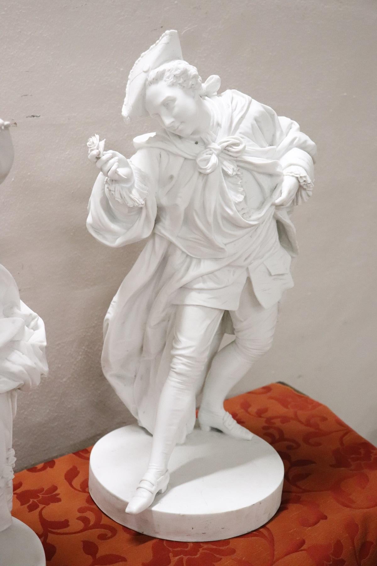 Beautiful biscuit porcelain sculptures. A loving couple in 19th century clothes. The boy hands a flower to his beloved. Great artistic quality, please look at the details made with perfection.