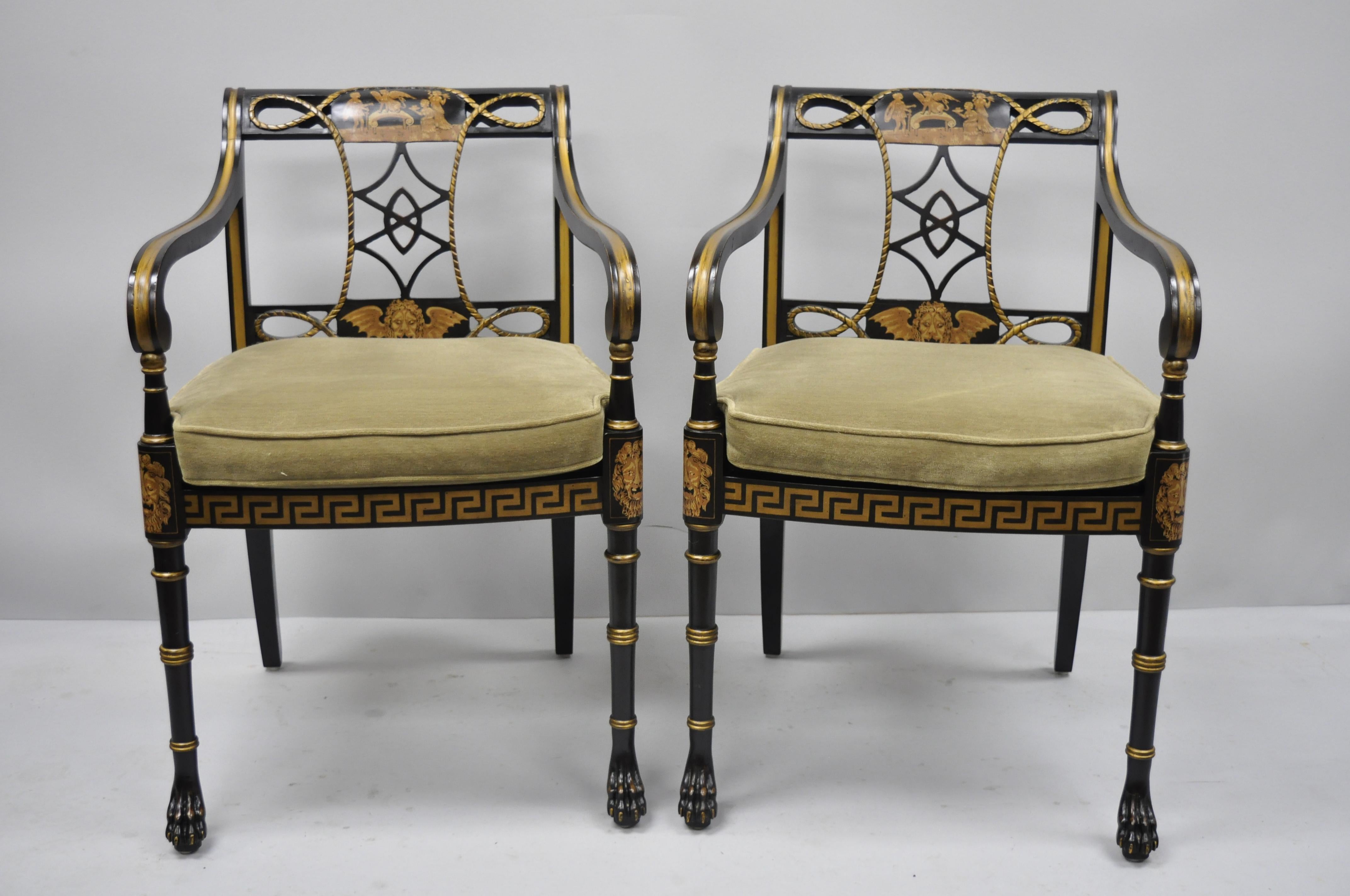 20th century black and gold English Regency style Greek key paw foot armchairs. Items feature cane seat, loose cushion, figural paint decorated backrest, Greek key paint decorated lower rails, solid wood construction, distressed finish, carved paw