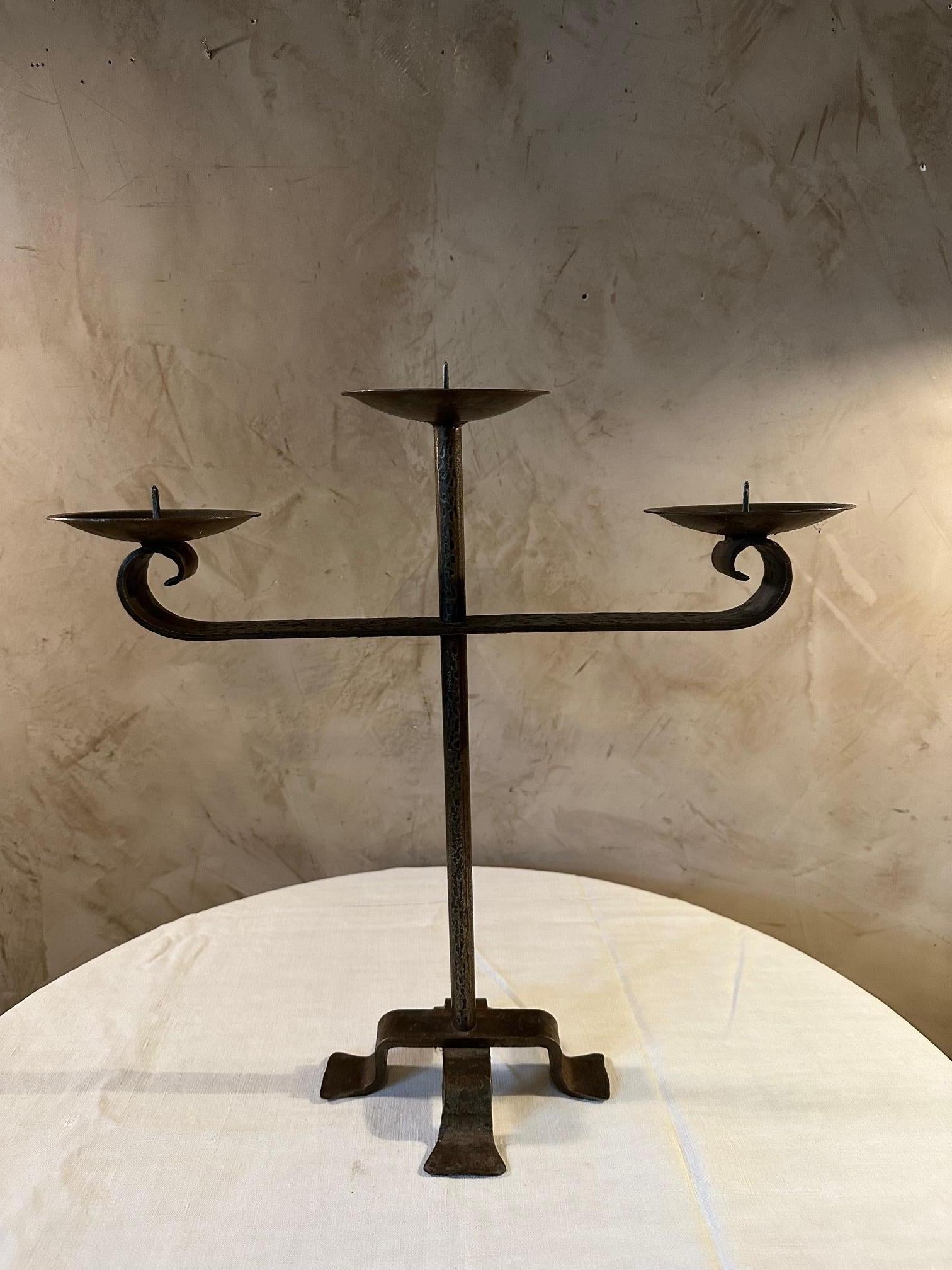 Wrought iron candlestick with three branches dating from the 1950s. 
Ideal for a warm decoration with beautiful candles.