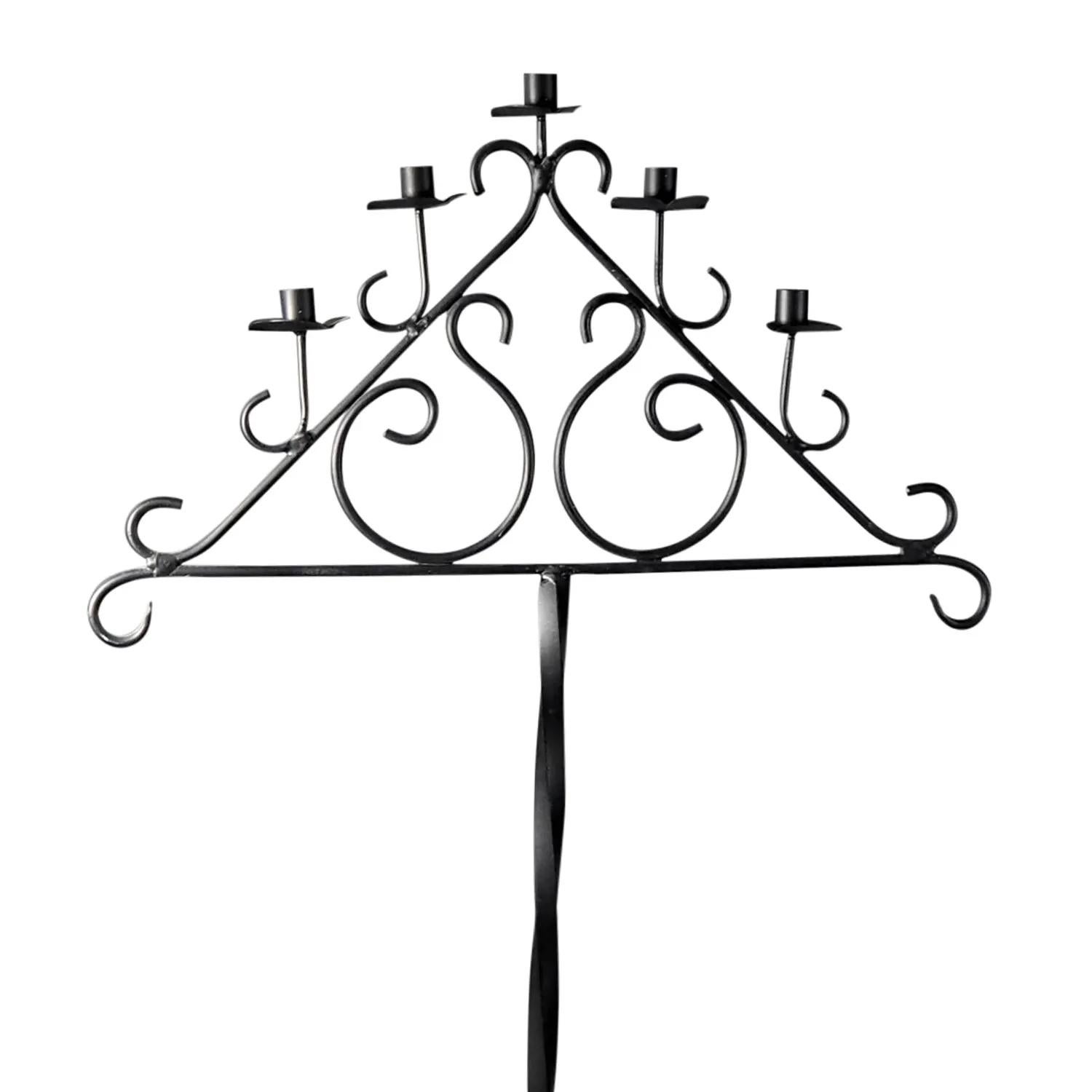 A black, vintage Art Deco French floor candelabra made of handcrafted forged metal and wrought iron, in good condition. The detailed candle holder is composed with five candle sticks. The stem of the décor piece is supported by four curved,