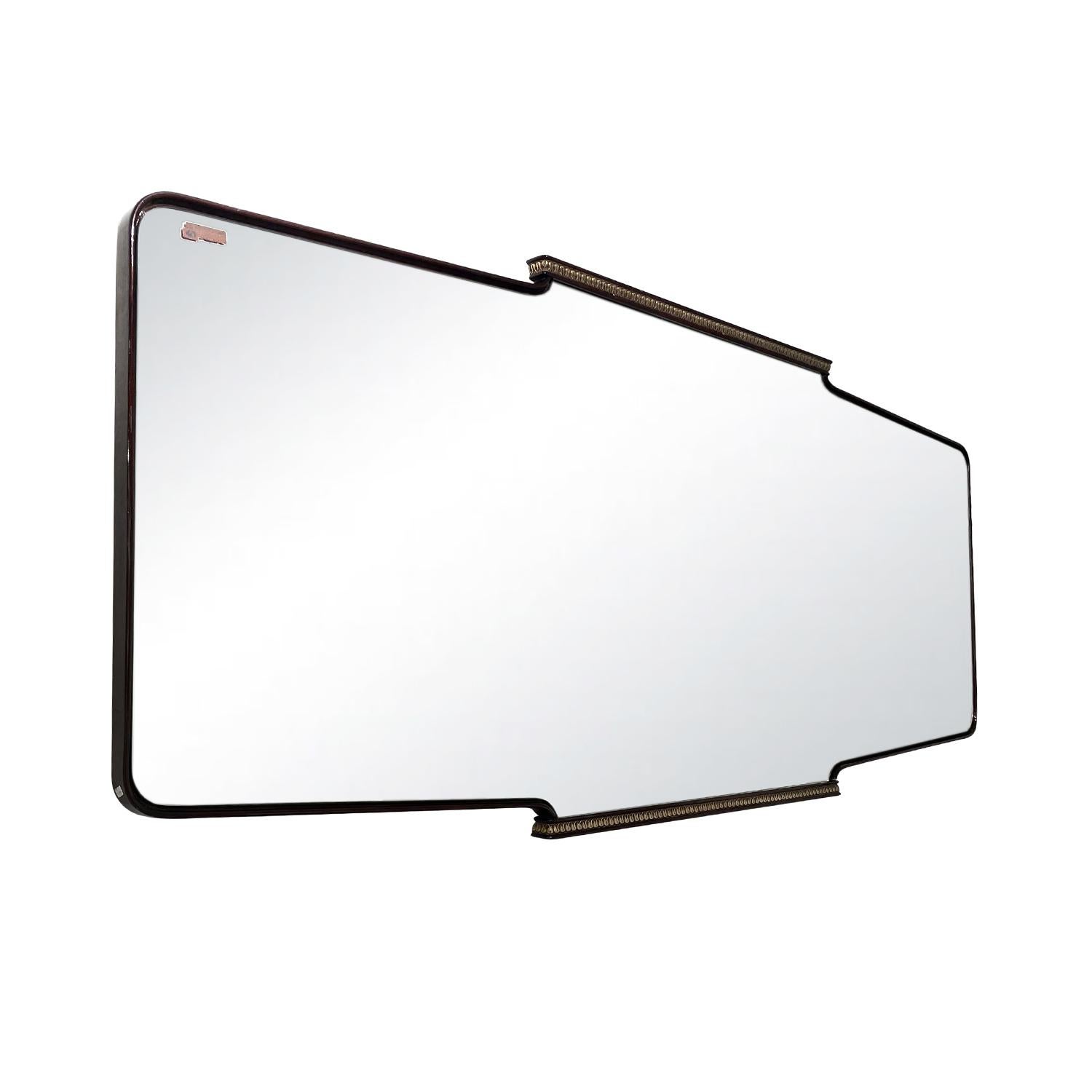 A large, vintage Mid-Century modern Italian rectangular wall mirror made of hand crafted ebonized Walnut designed by Osvaldo Borsani, in good condition. The mirror is consisting its original mirrored glass, enhanced by detailed brass décor. Wear