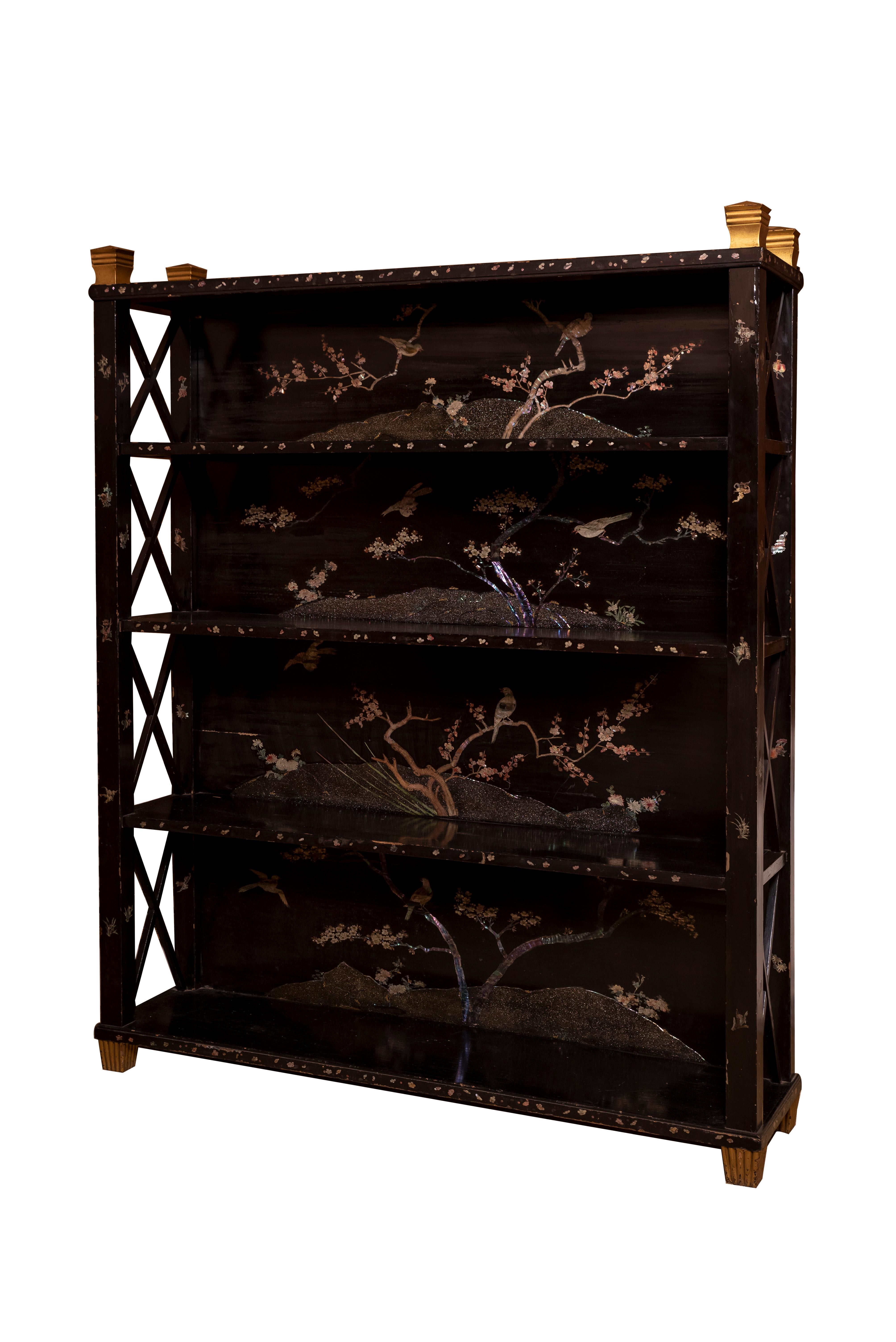 A 20th century british chippendale style black lacquered bookcase.
With 19th century mother of pearl pannels depicting birds and floral motives.