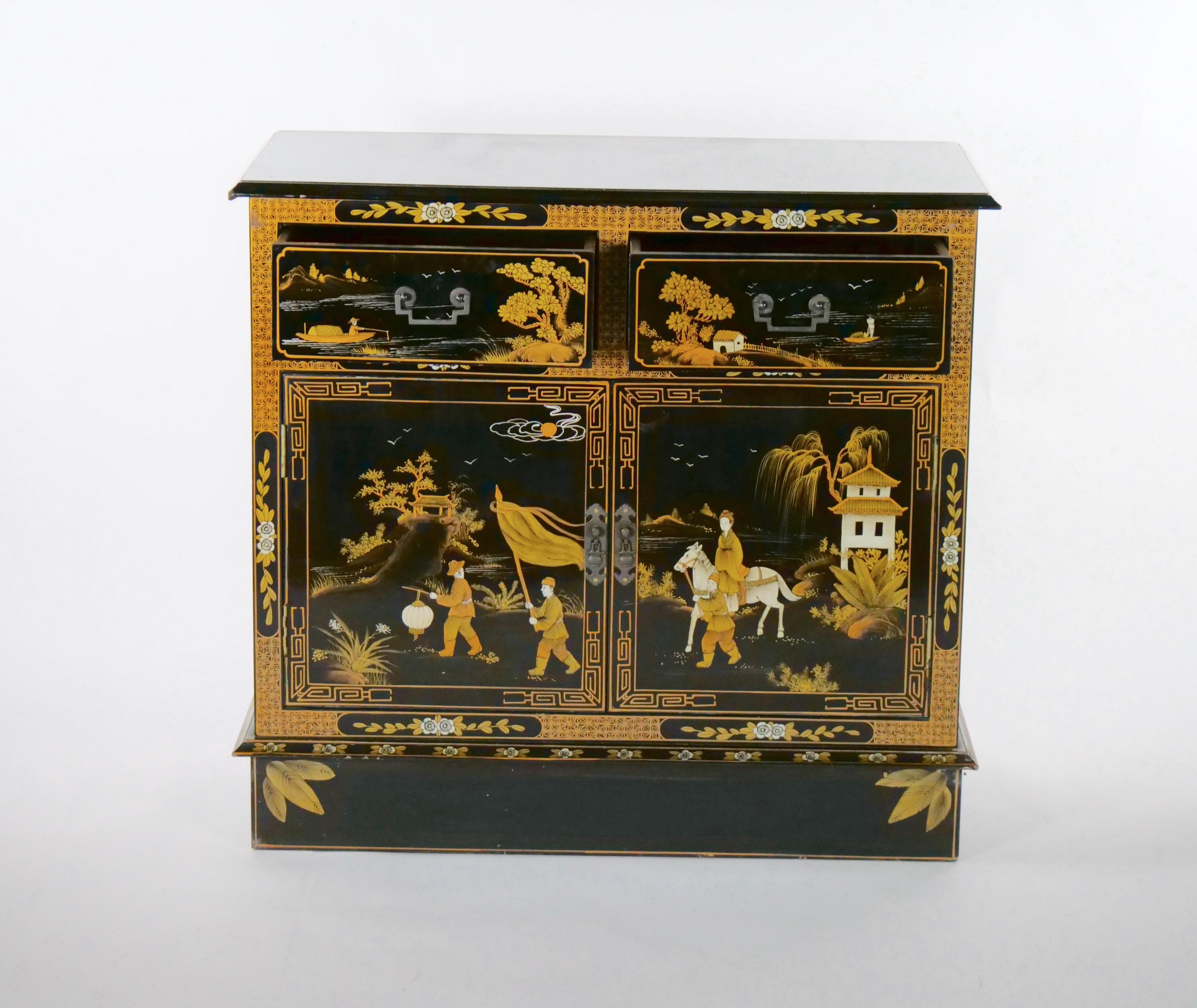 Beautifully hand painted and decorated black lacquer wood small server / dry bar. The server features heavy hand painted chinoiserie scene all around with two front top pull drawer under a double door. The sideboard is in great condition, minor wear