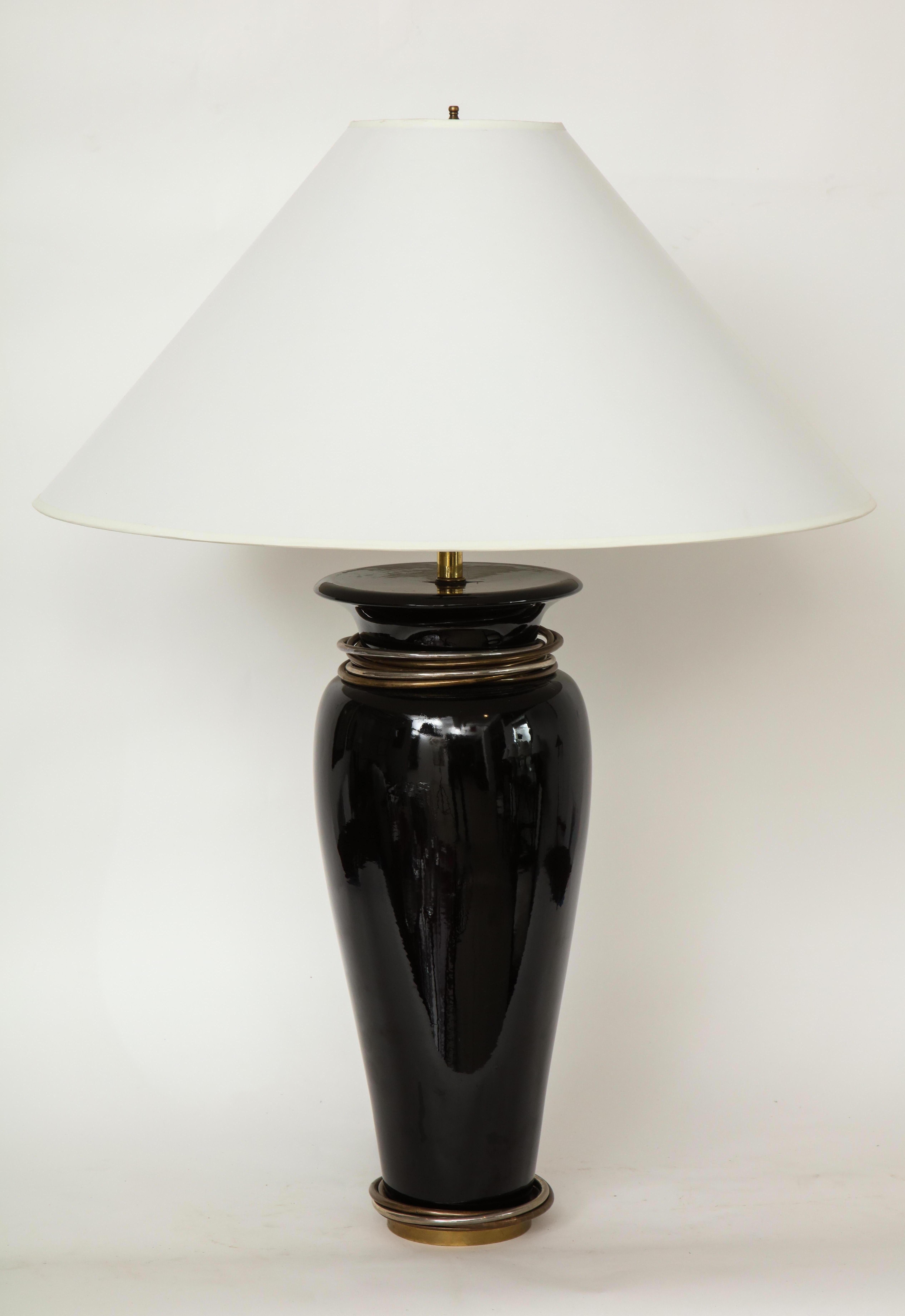 20th century black porcelain lamp, ovoid form vase shaped with short waisted neck and everted rim mounted with silver and patinated stacked rings.
'Chapman'.