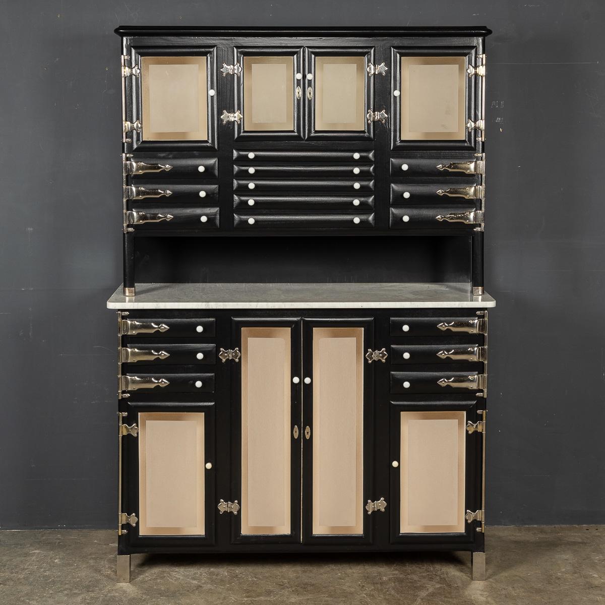 An exquisite piece from the 20th century, this sizable dentist cabinet, skillfully crafted and coated in a rich black finish, bears the signature style of the renowned Italian supplier, Alessandro Weiss. The cabinet showcases meticulous attention to