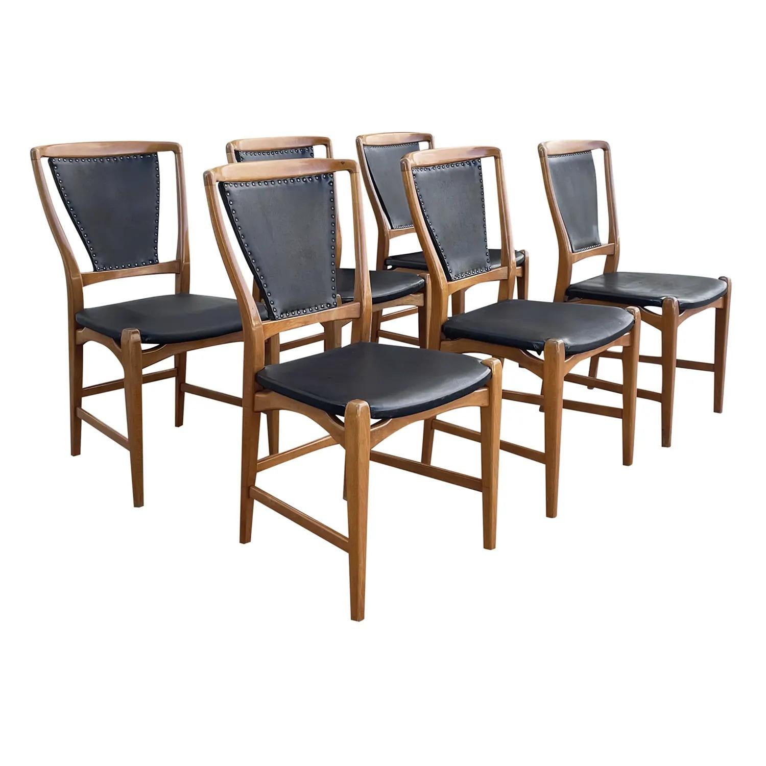 A black, vintage Mid-Century Modern Swedish set of six dining chairs made of hand carved Pearwood, designed and produced by an unknown architect from Stockholm, in good condition. The seat, back rest of the Scandinavian side chairs are are