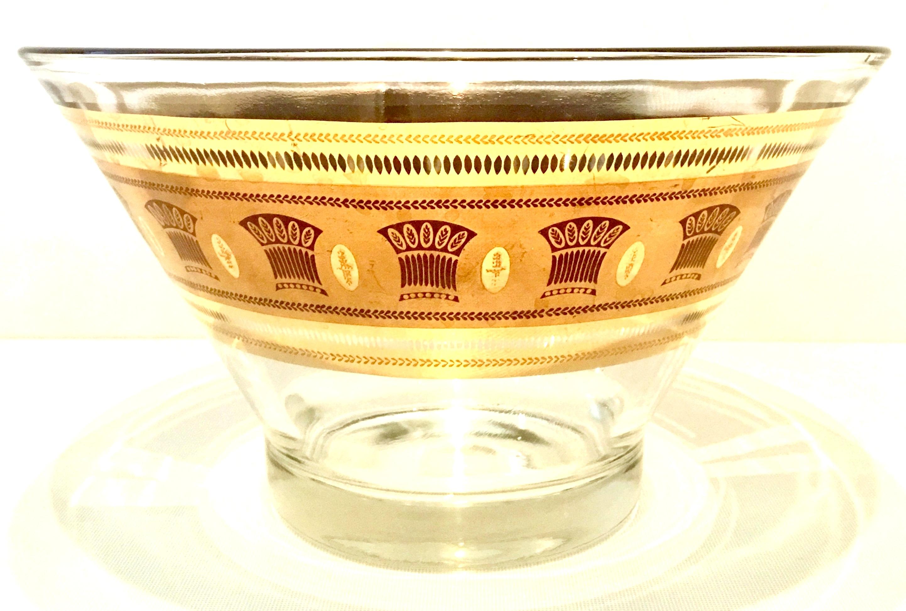 20th century blown glass printed 22-karat gold drinks set of nine pieces by, Culver. This blown glass with a sheaf of wheat motif is finished in 22-karat gold and white. Set includes, one large multi purpose round serving bowl and eight high ball