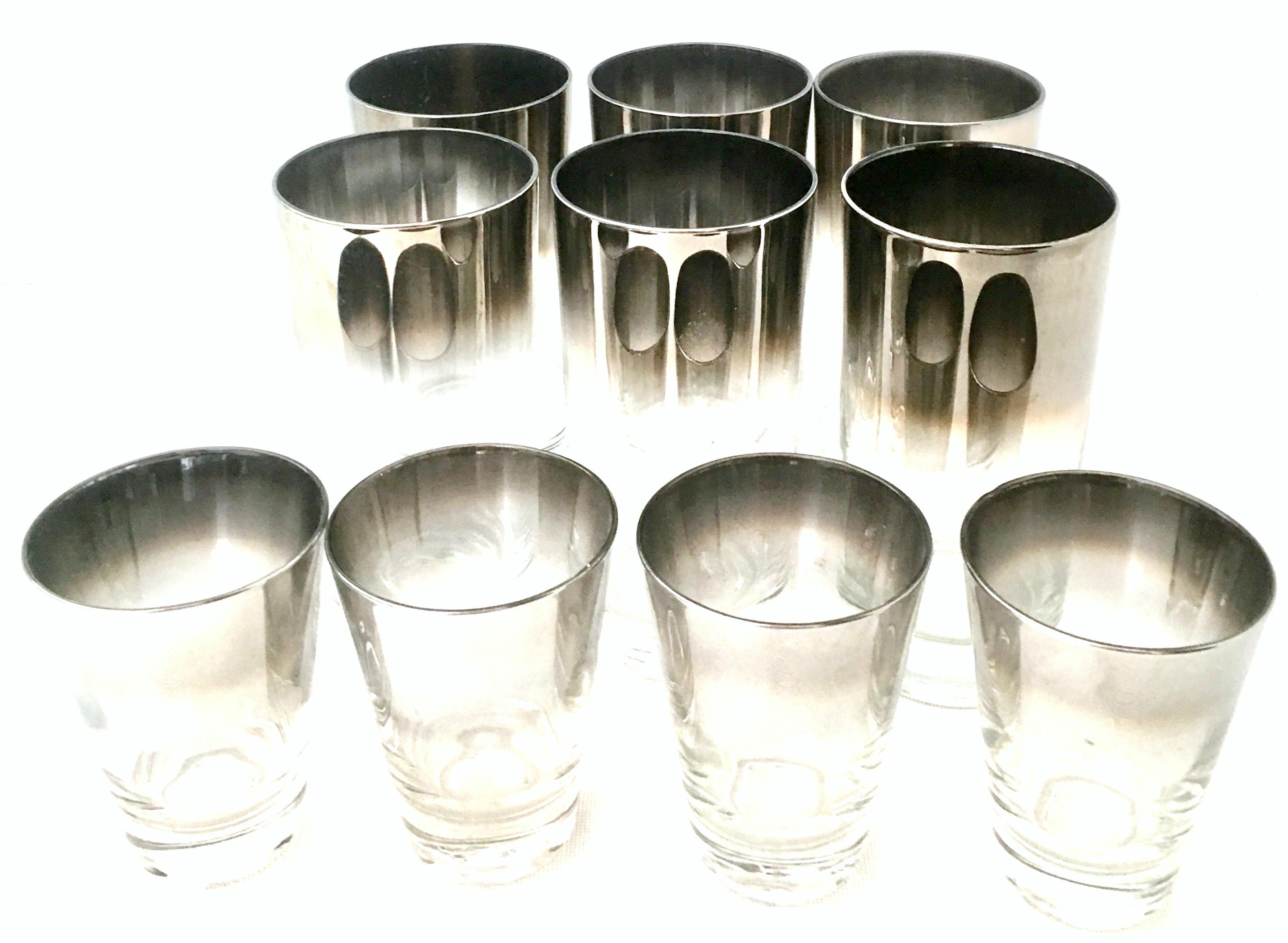 20th century blown glass and sterling silver drinks set by, Dorothy Thorpe, set of 10. Set includes, six high ball drink glasses and four cocktail glasses. Features a translucent base with sterling silver overlay edge.
The cocktail glass measures: