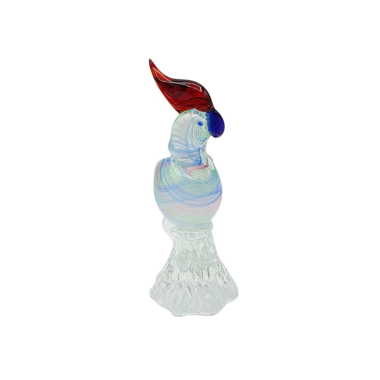 A blue-red vintage Mid-Century Modern Italian parrot sculpture made of hand blown Murano Glass, designed and produced by Archimede Seguso in good condition. The décor piece is particularized by multicolored details. Wear consistent with age and use.