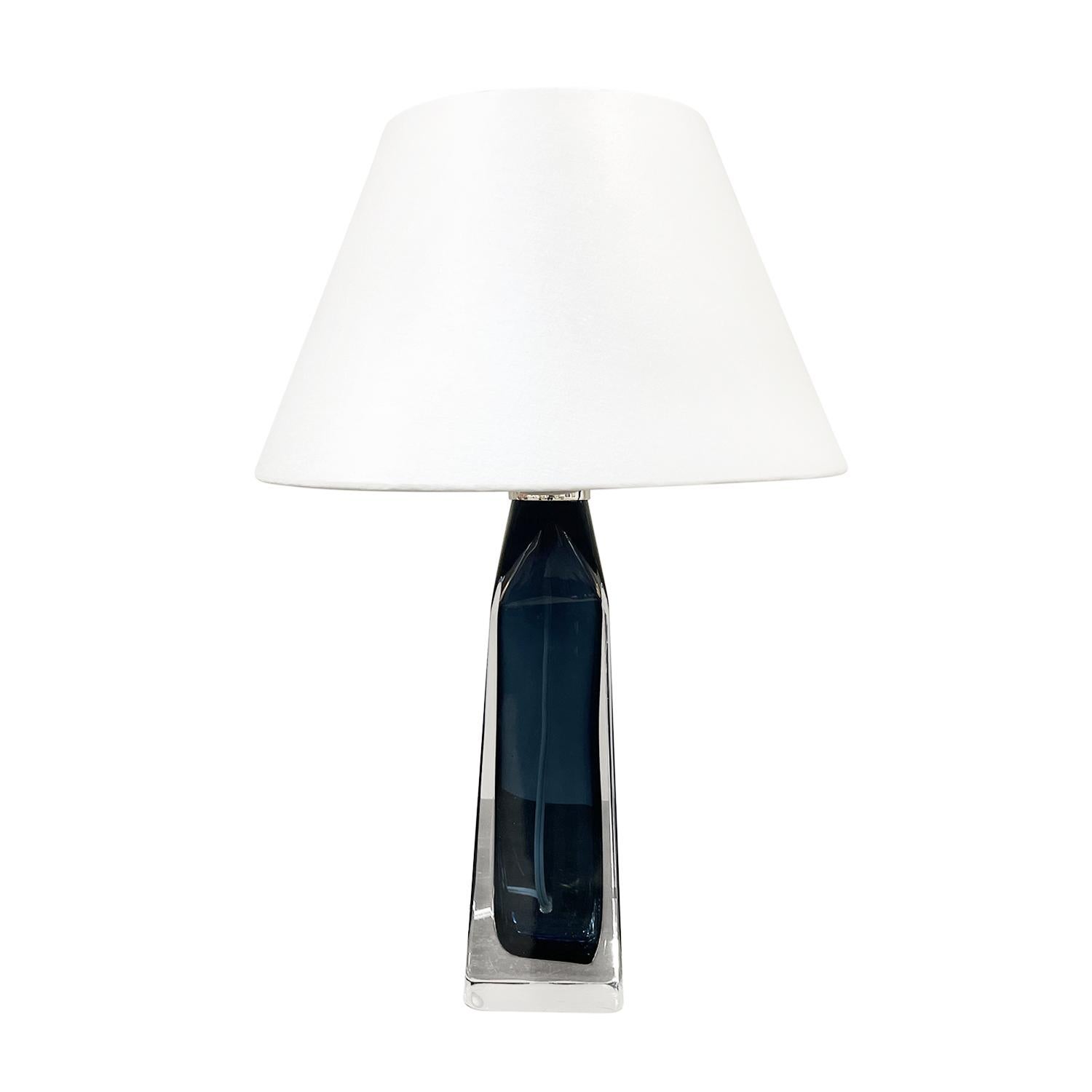 A light-blue vintage Mid-Century Modern Swedish table lamp with a new white round shade made of hand blown clear Orrefors glass, designed by Carl Fagerlund and produced, signed by Orrefors in good condition. The Scandinavian desk light is enhanced