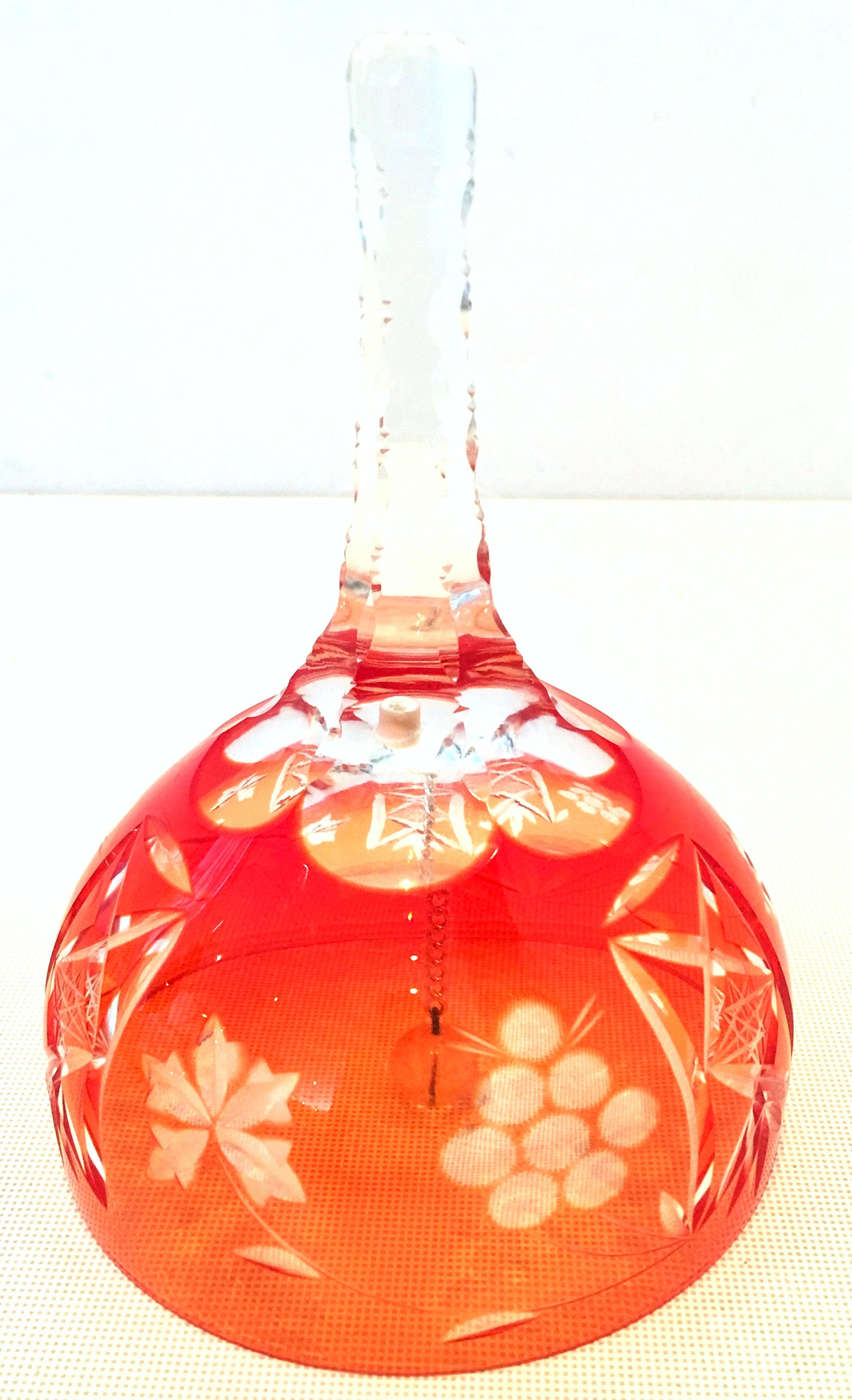 20th century Bohemia crystal dinner bell. This cut to clear crystal dinner bell features an orange to red tone and silver chain to crystal ball.