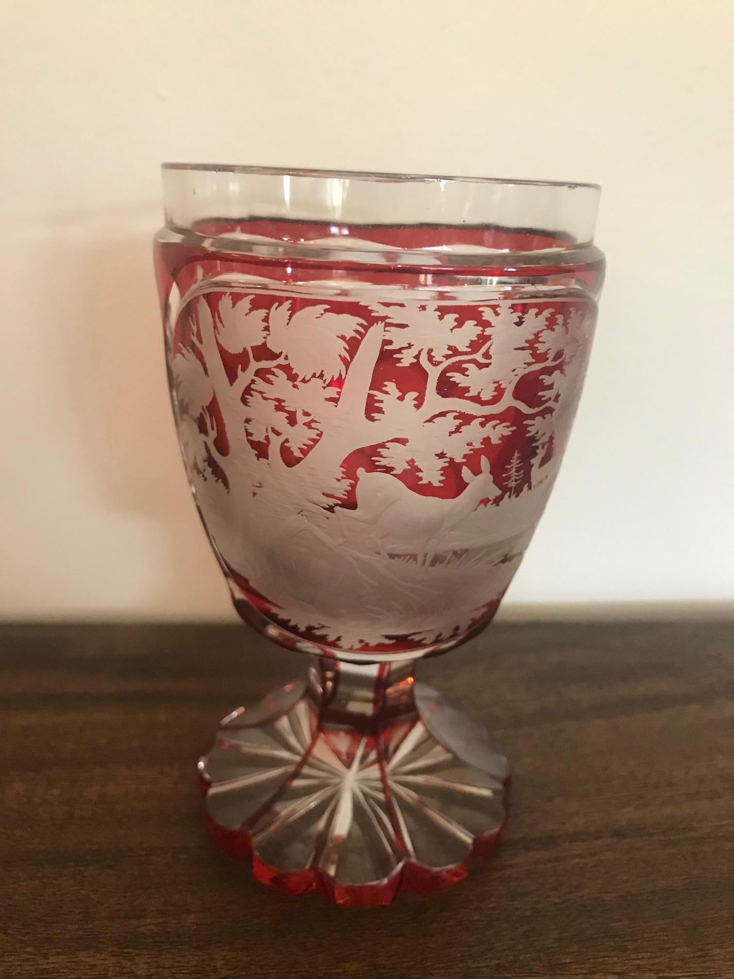 Beautiful 20th century Bohemian engraved crystal glass or cup from the 1920s.
Engraved red crystal Hunt scene, we can see many dears in the forest and large round engraved in the crystal.
The base looks like a flower.
Exceptional quality. Good