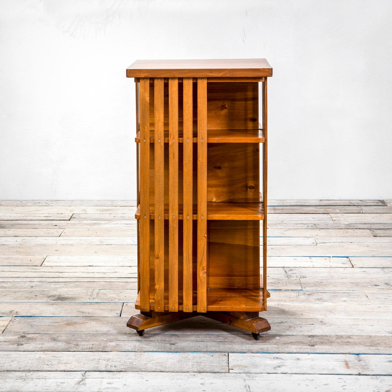 Wooden bookcase designed and produced in '50s in Italy. The bookcase should be set as a centre furniture considering that it has possibility to reach the shelves from each side. The bookcase is entirely in wood and it has 4 wheels at the basement