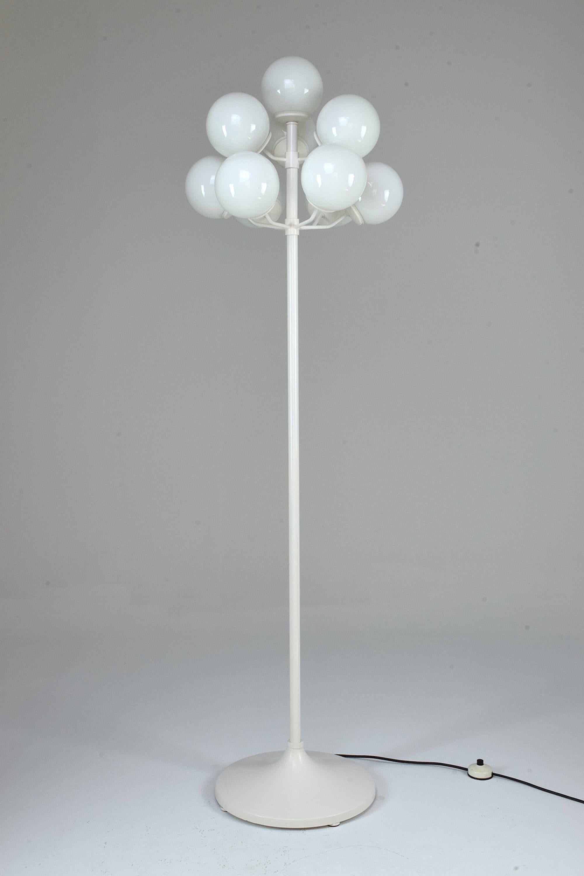 A 1960s vintage floor lamp in the style of Swedish designer Max Bill's iconic design. This piece is built with 10 atomic style boule opal glass shades standing on a white re-lacquered metallic structure. 


We are an exhibition space and an