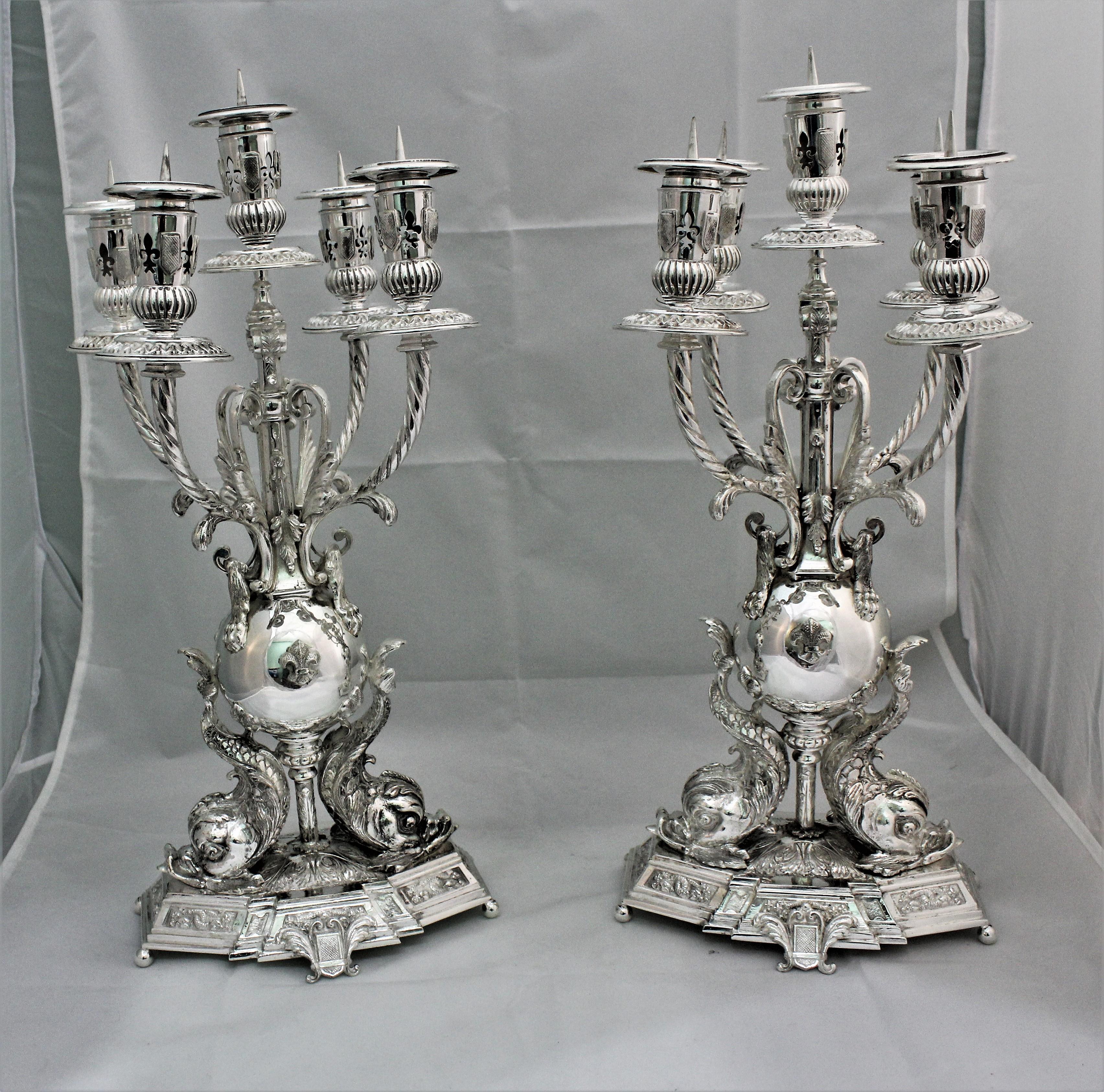 Pair of silver candelabras realized around 1950s in Florence by the famous Florentine silversmith 
Brandimarte.
Impressive dimension H 52 cm x 22 x 20 cm – total weight over 7 kg
Base octagonal upon which there are 2 tritons holding the upper