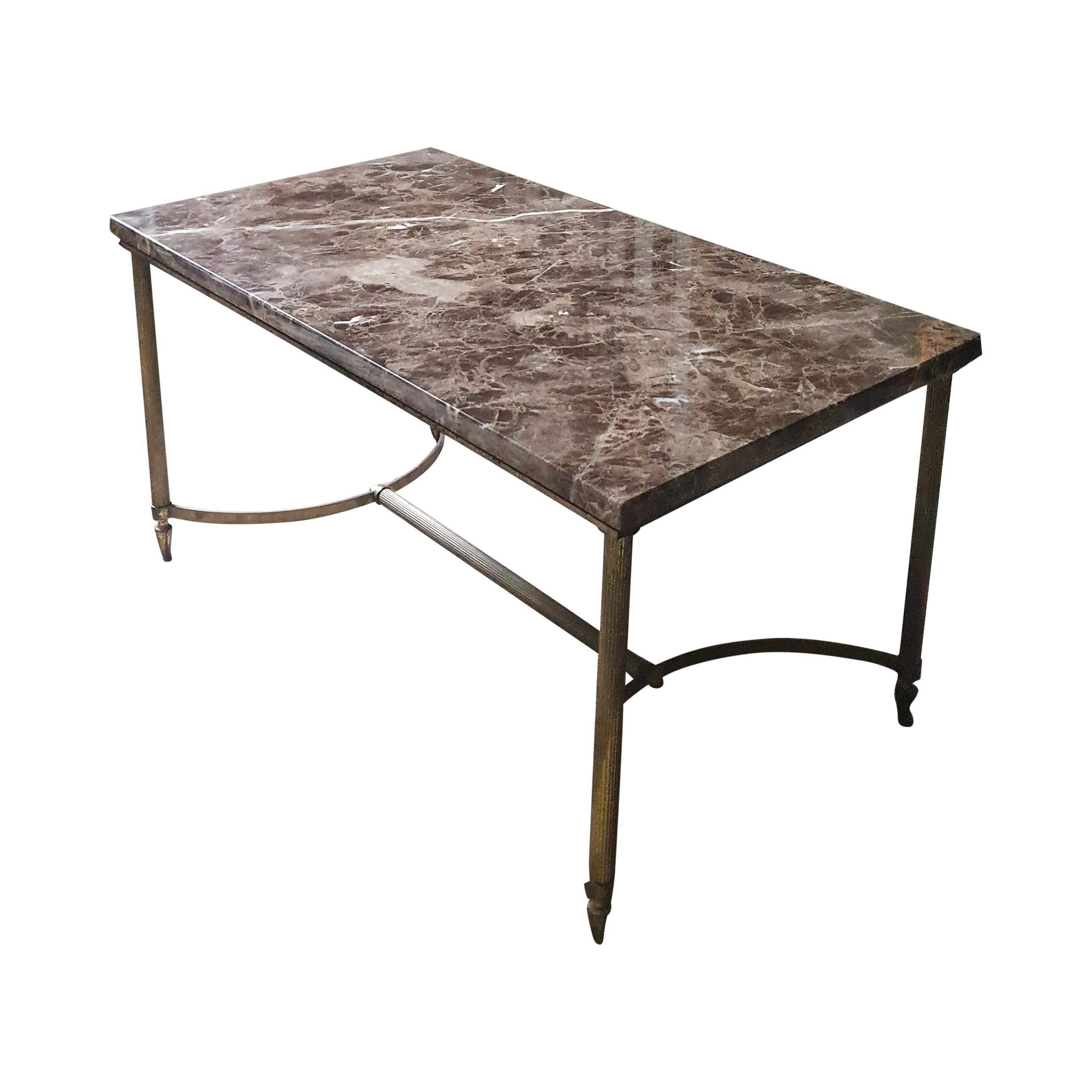 A beautiful hand crafted brass, bronze and marble coffee table circa 1960s. This lovely compact table has elegant cast Bronze feet which support thick fluted brass legs, the legs are attached to each other with semi circular Bronze bands connected