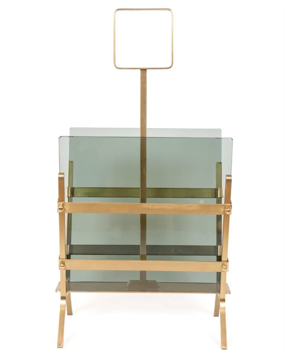 This stylish and sophisticated magazine holder is fitted with removable smoked green glass and is solid in its design and construction. 
With the removable glass inserts you may decide to customize your holder with bronze, black, gray glass or even