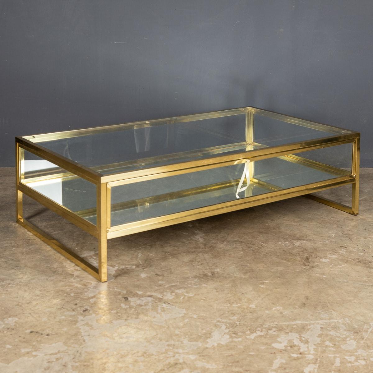 A French vitrine coffee table made by the design house Maison Jansen with gliding glass top. Made in brass with white metal detail and original bevelled glass and mirrored base.

CONDITION
In Great Condition - wear consistent with