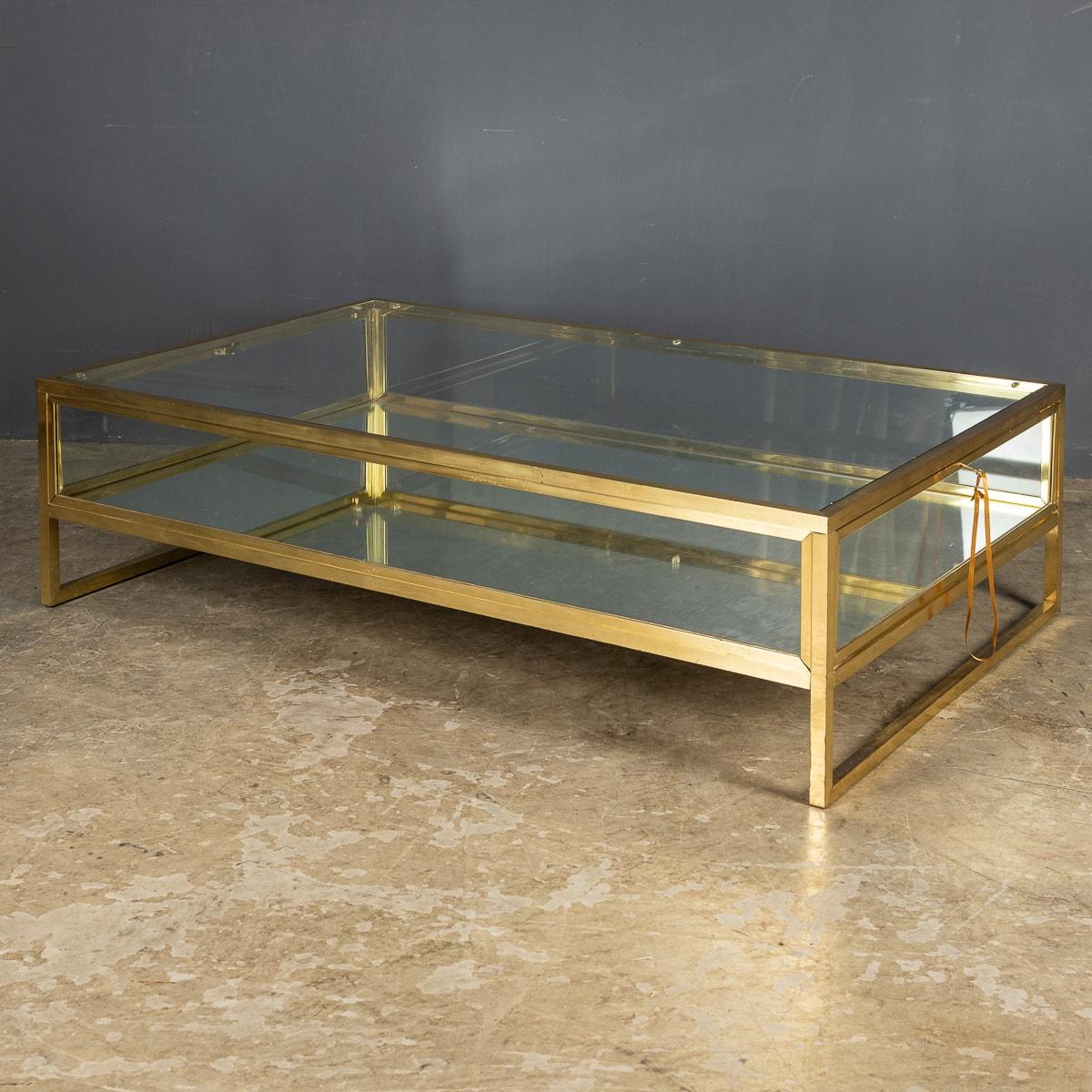 A French vitrine coffee table made by the design house Maison Jansen with gliding glass top. Made in brass with white metal detail and original bevelled glass and mirrored base.

CONDITION
In Great Condition - wear consistent with