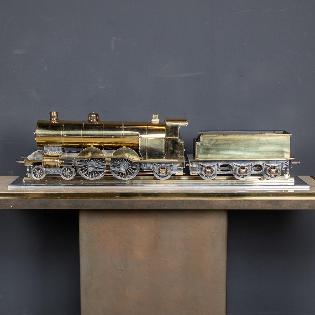 Early 20th Century brass model, showcasing the GNR Atlantic locomotive 251 and its three-axle tender. Crafted to a 3 1/2 inch gauge, the model gleams with polished brass, copper, and steel elements. Intricate details within the cab, such as the