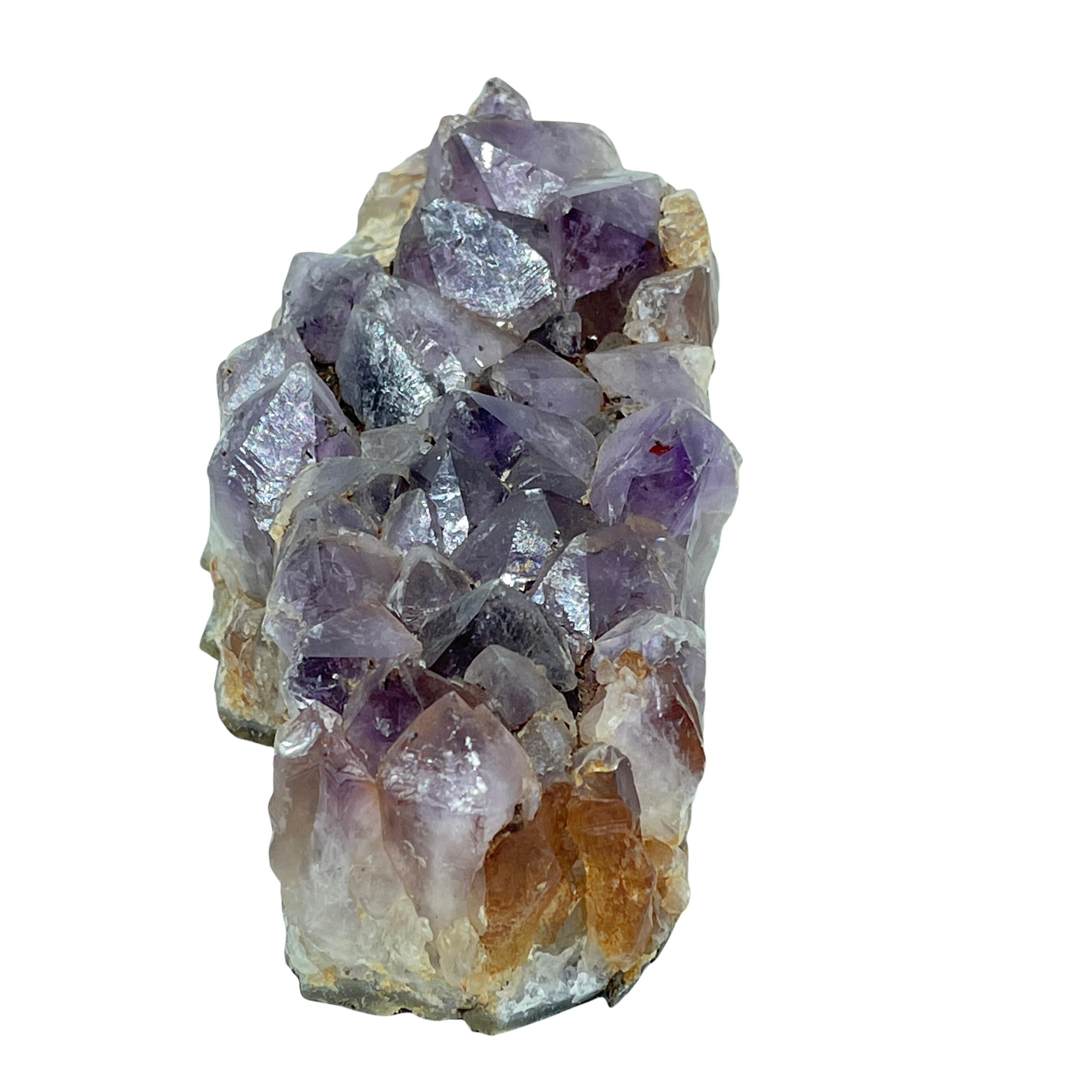 This stunning and sculptural amethyst geode were found in Brazil, where many of the world's most precious and exquisite gems are mined. It feature unfinished back showcasing the exterior of the geode in grisaille tones, and the interior geode form