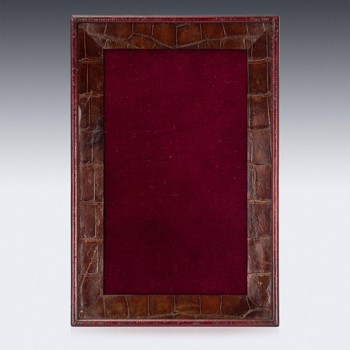 Stylish early-20th century British made sumptuous crocodile leather photograph frame, of rectangular form, covered behind glass and on a strut support. Made and Retailed by Lockwood & Co, 75 New Bond st, London. A really manly statement piece and a