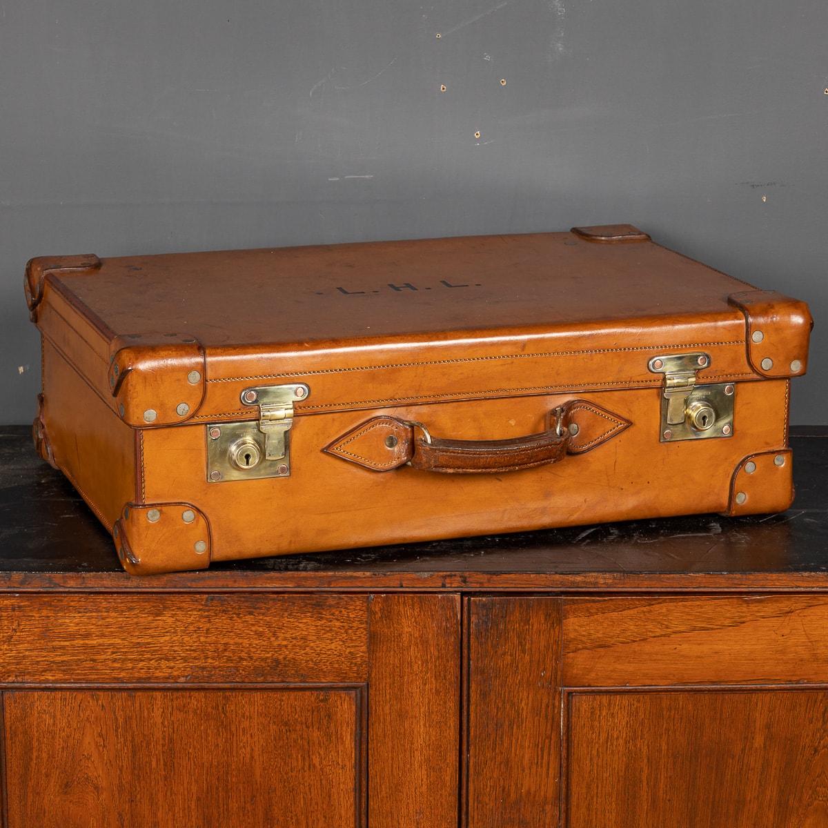 Antique early 20th Century British made Bridle hide covered suitcase. The leather shows wear but is still supple, mounted with brass fittings, oozing charm and elegance. A truly great piece for any collector.

CONDITION
In Good Condition - wear as
