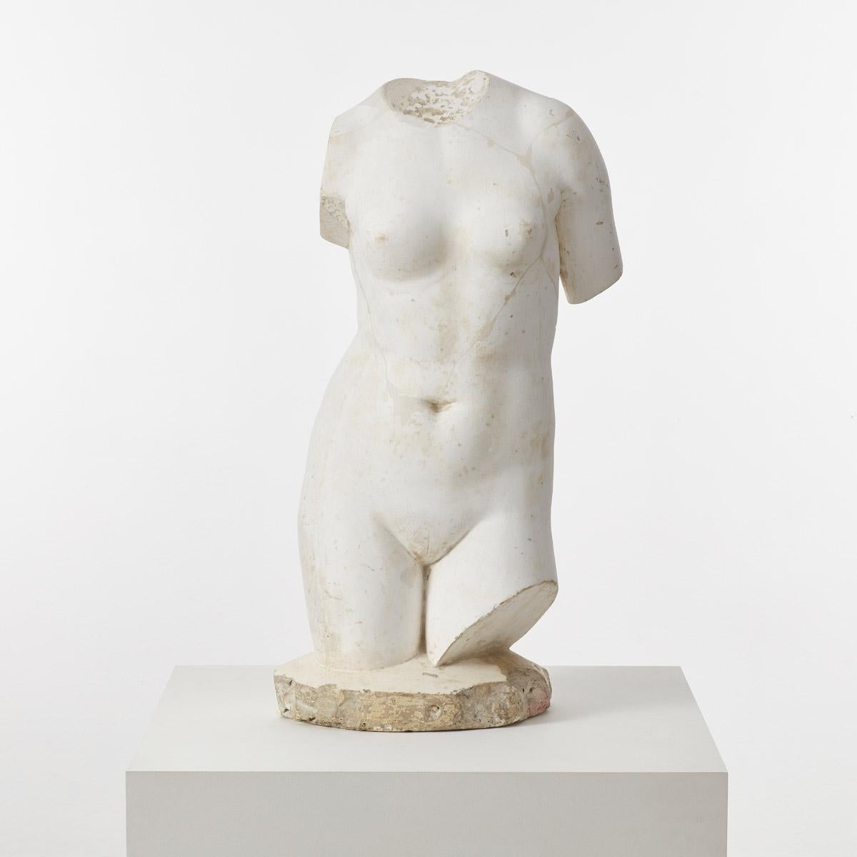 A striking plaster cast of a classical female torso, reputedly reclaimed from a museum. The surface has an antiquated finish, with signs of wear, repairs, chips and marks.