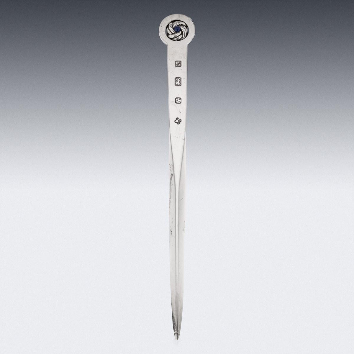 20th Century British solid silver letter opener, terminating with a woven silver decoration mounted with a lapiz cabochon, in its original retail case. Hallmarked English silver (925 standard), London, year 1996 (W), Maker A&CoLtd (Asprey & Co