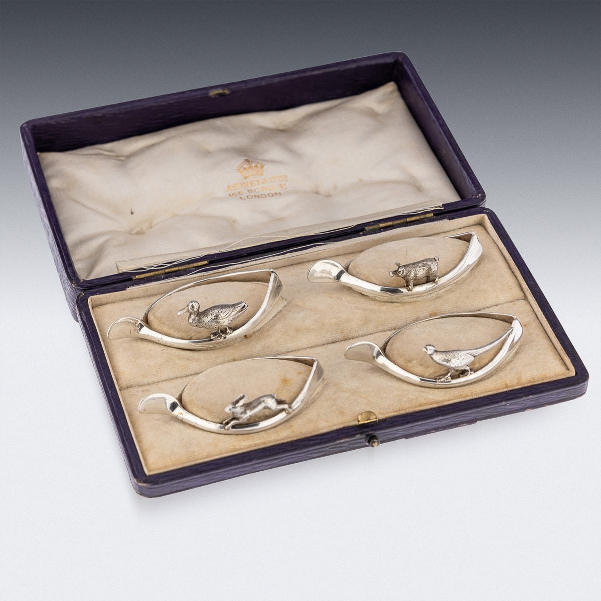 Antique 20th Century stunning set of four solid silver 'lucky animals' napkin rings. Each napkin holder is in a shape of a wishbone and mounted with cast animals, depicting a duck, pig, rabbit and a pheasant. The set comes in an original retail