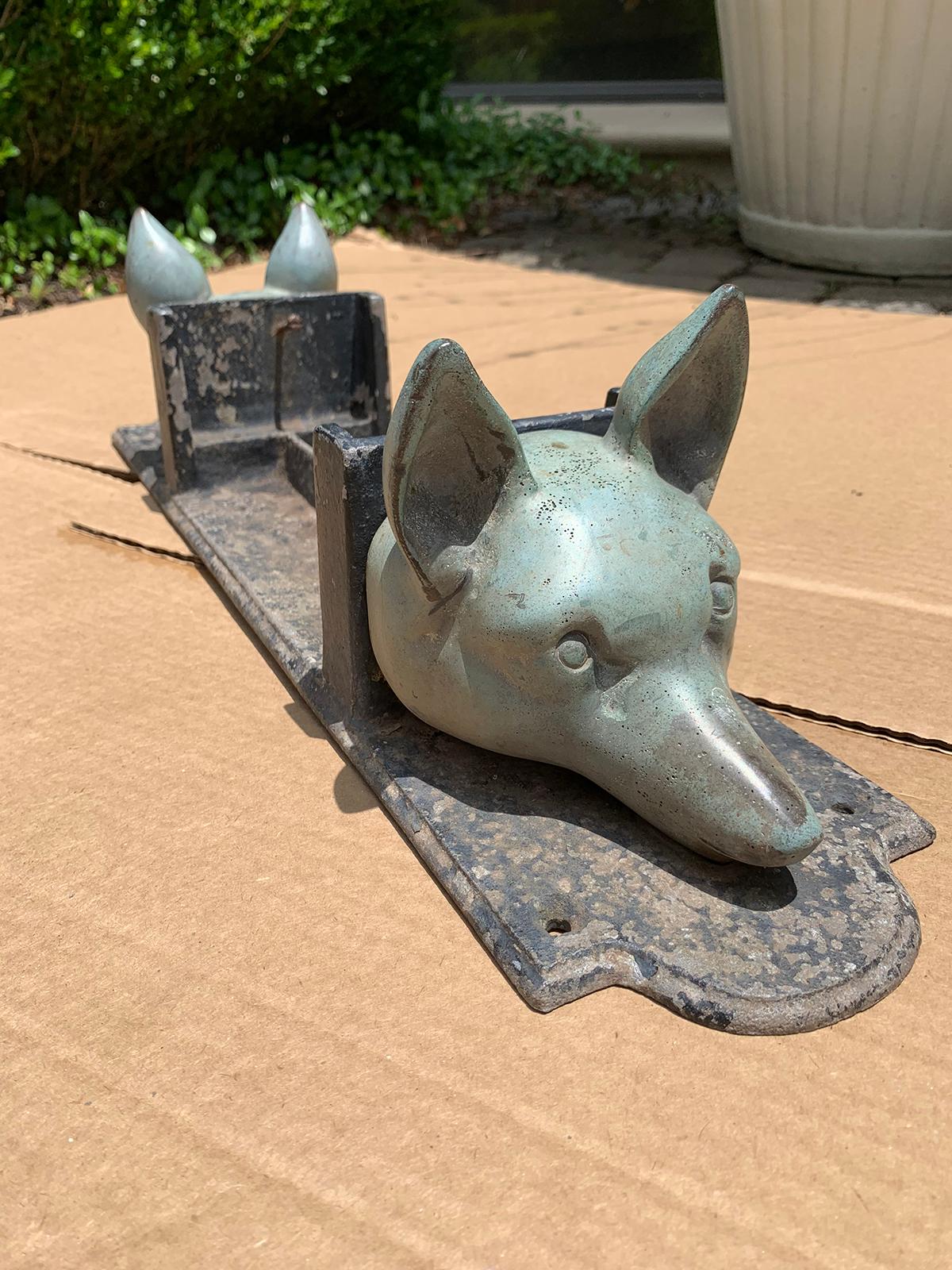 20th century bronze and iron equestrian boot scrape with two fox heads.