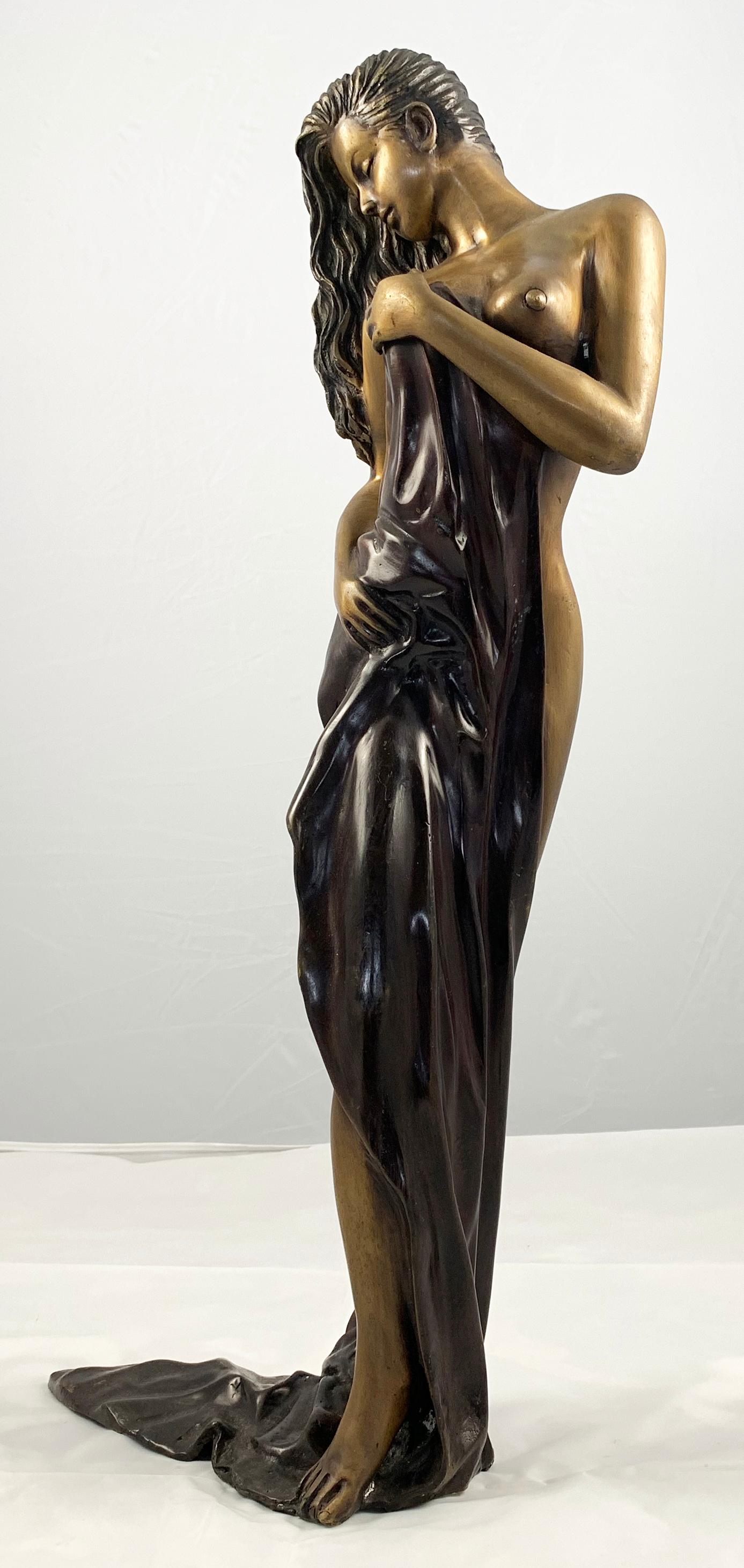 Bronze figure of an elegant semi-nude Woman, draped in robes.