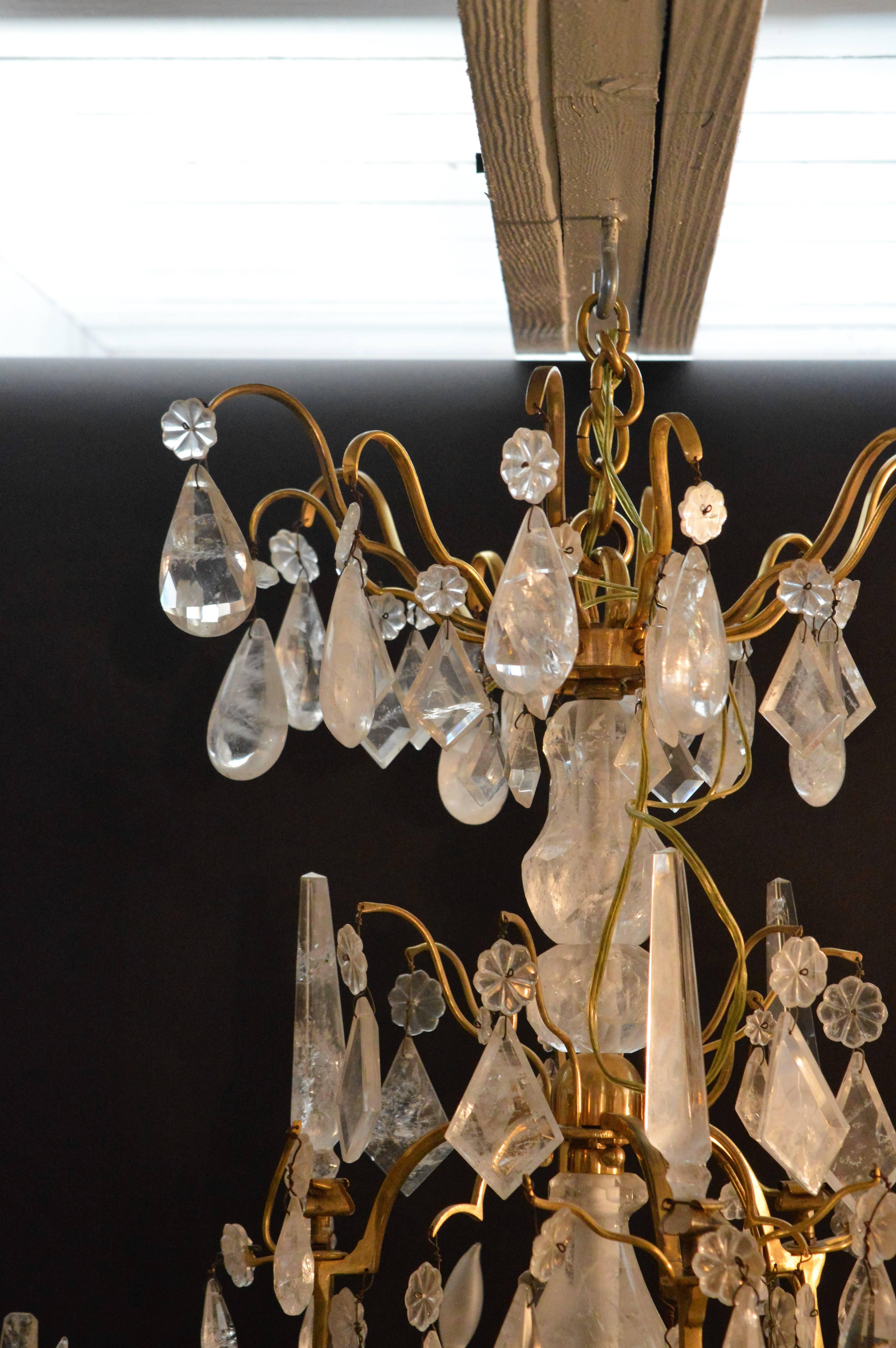 Early 20th century nine-light bronze rock crystal chandelier. The center of the chandelier is all rock crystal and adorned with beautiful rock crystal pendants.