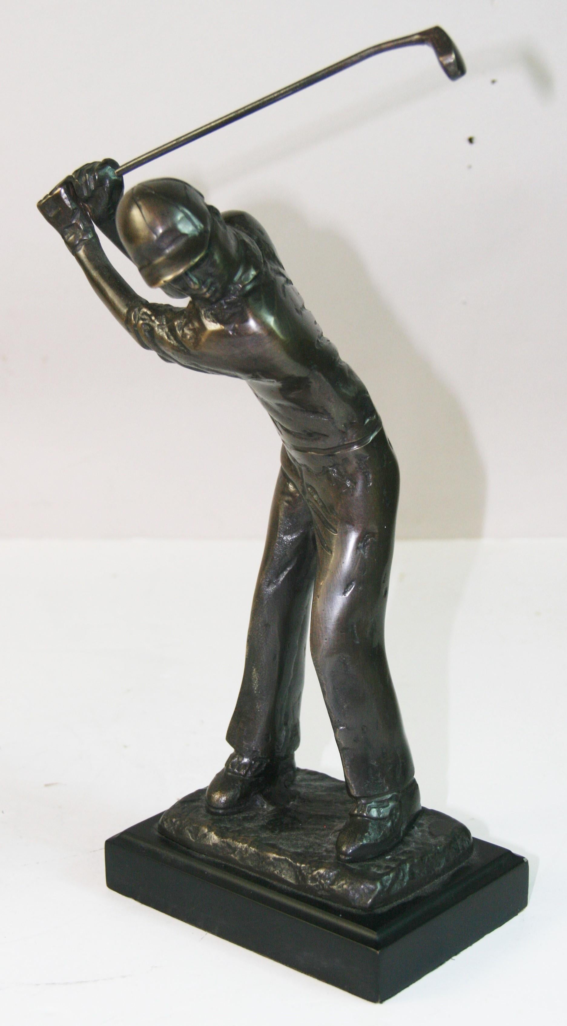 1758 Bronze golfing sculpture made of bronze  on wood base in a full backswing positin.