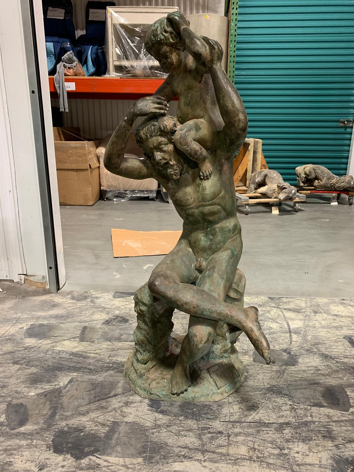 20th century bronze sculpture of man with boy on shoulders.