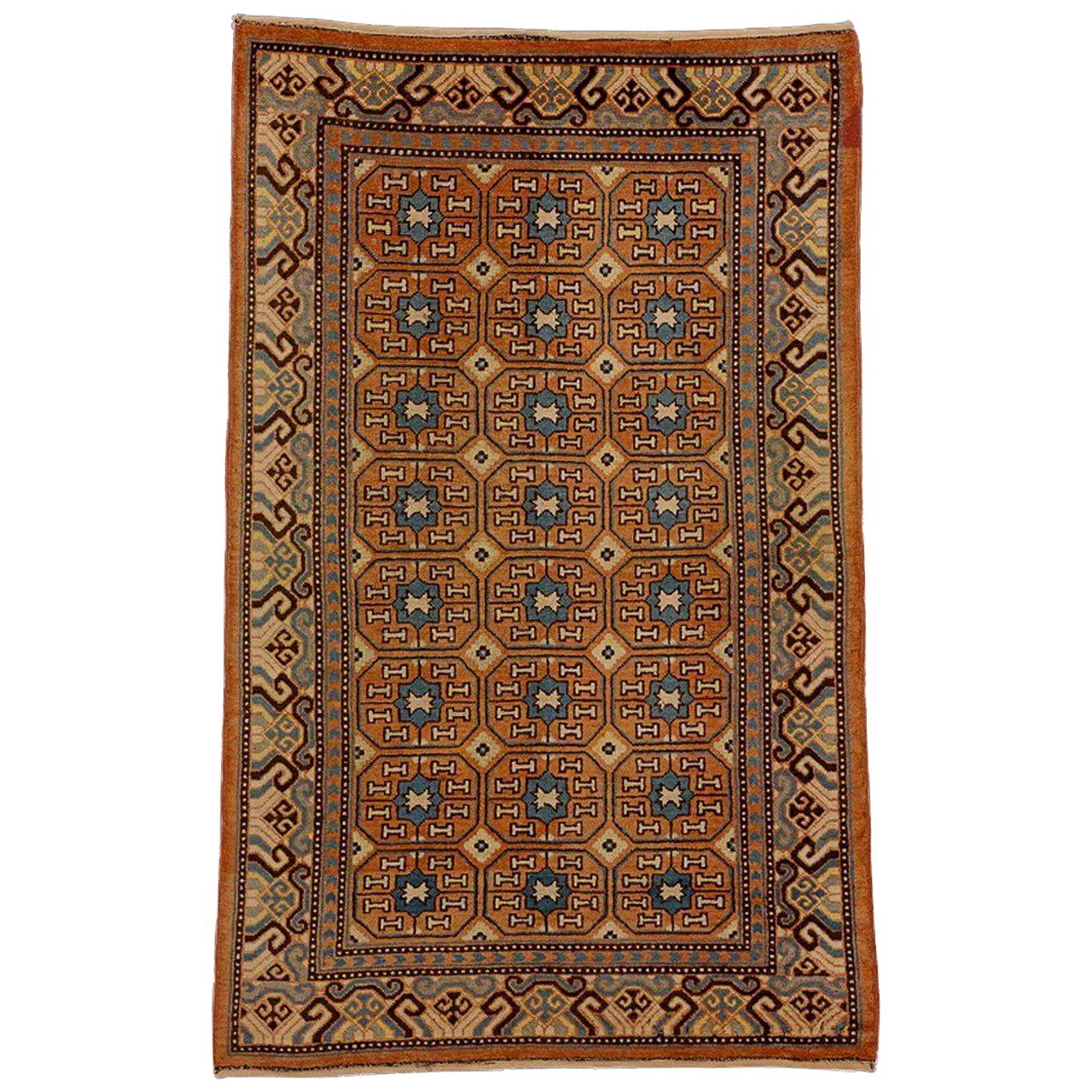 19th Century Brown and Blue Stylized Rosette Gul Chinese Khotan Rug, circa 1870s