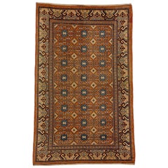 Alfombra china Khotan Gul del siglo XIX, marrón y azul con roseta estilizada, hacia la década de 1870