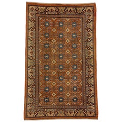 Tapis Khotan chinois du 19ème siècle en rosette stylisée marron et bleue, vers les années 1870