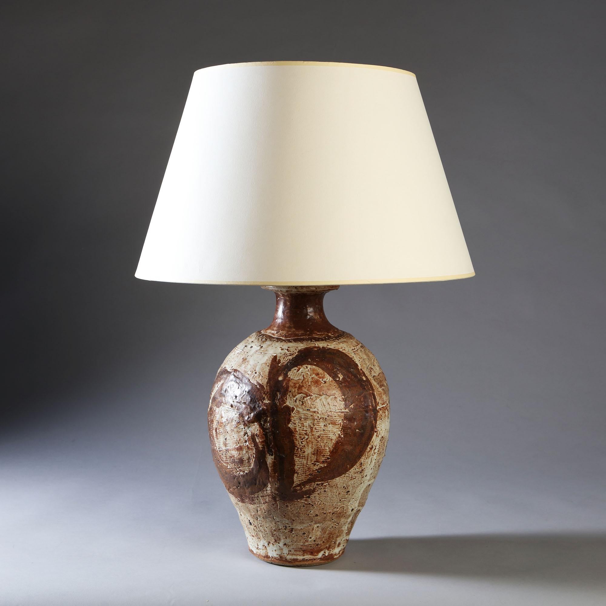 A 20th century art pottery vase, attributed to the Leach Pottery Studio, with varied earth coloured glaze and swirling rich brown decoration. Now converted as a lamp.

Currently wired for the UK. Please enquire for rewiring services.

Please note: